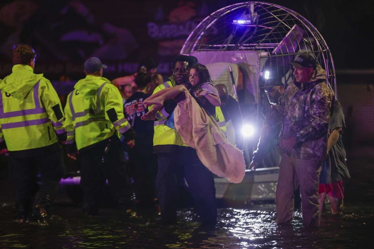 An airboat transports residents rescued from floodwaters in the aftermath of Hurricane Helene on Friday in Crystal River, Fla.