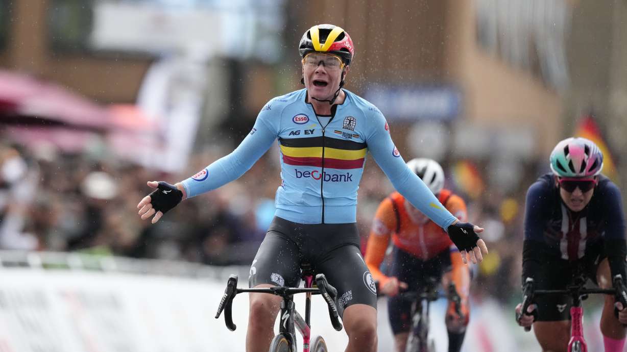 Belgium's Lotte Kopecky crosses the finish line to win the Women Elite road race of the Cycling and Para-cycling Road World Championships in Zurich, Switzerland, Saturday Sept. 28, 2024.