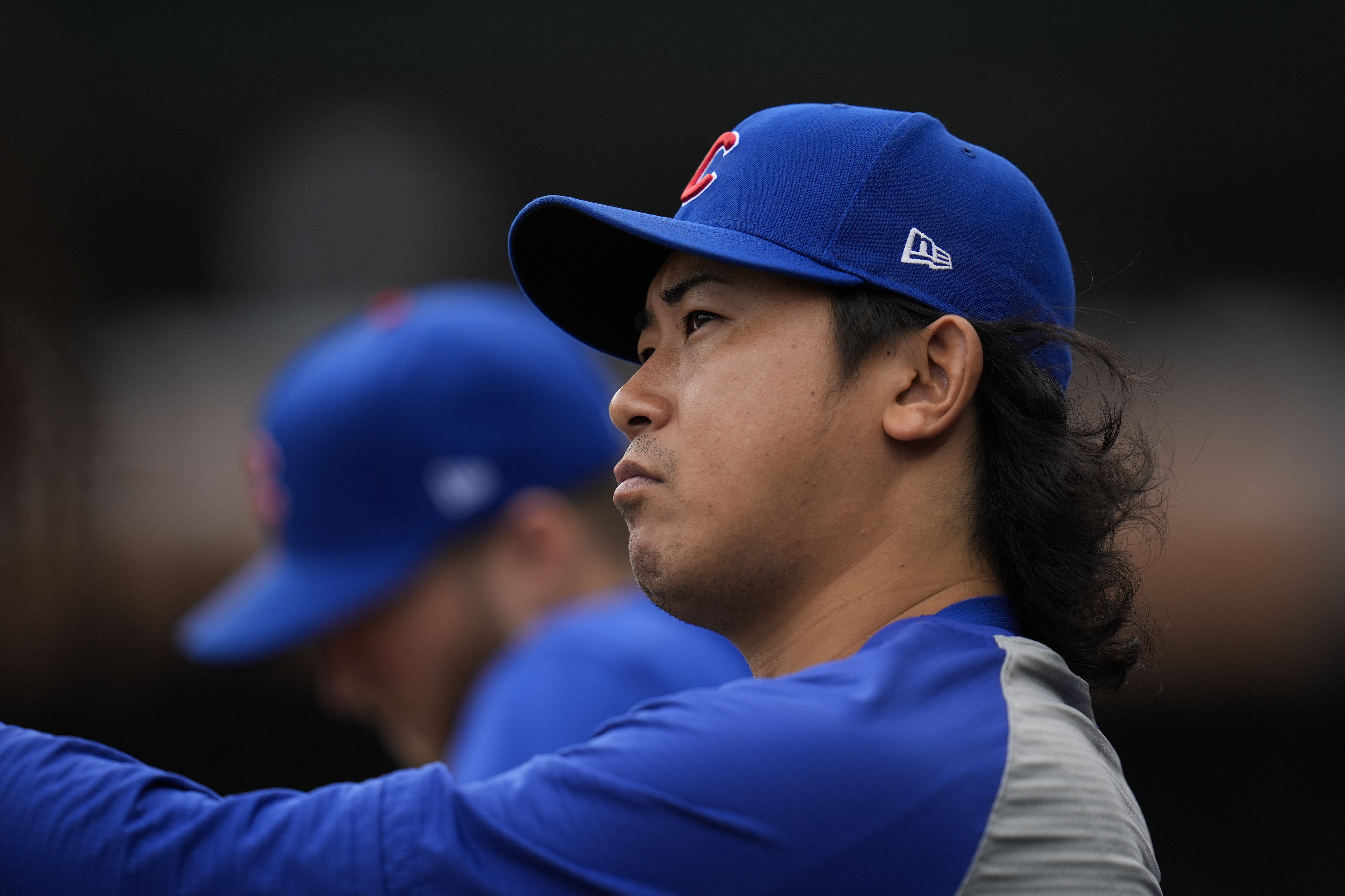 Chicago Cubs pitcher Shota Imanaga stands in the dugout during the first inning of a baseball game against the Cincinnati Reds, Friday, Sept. 27, 2024, in Chicago. 