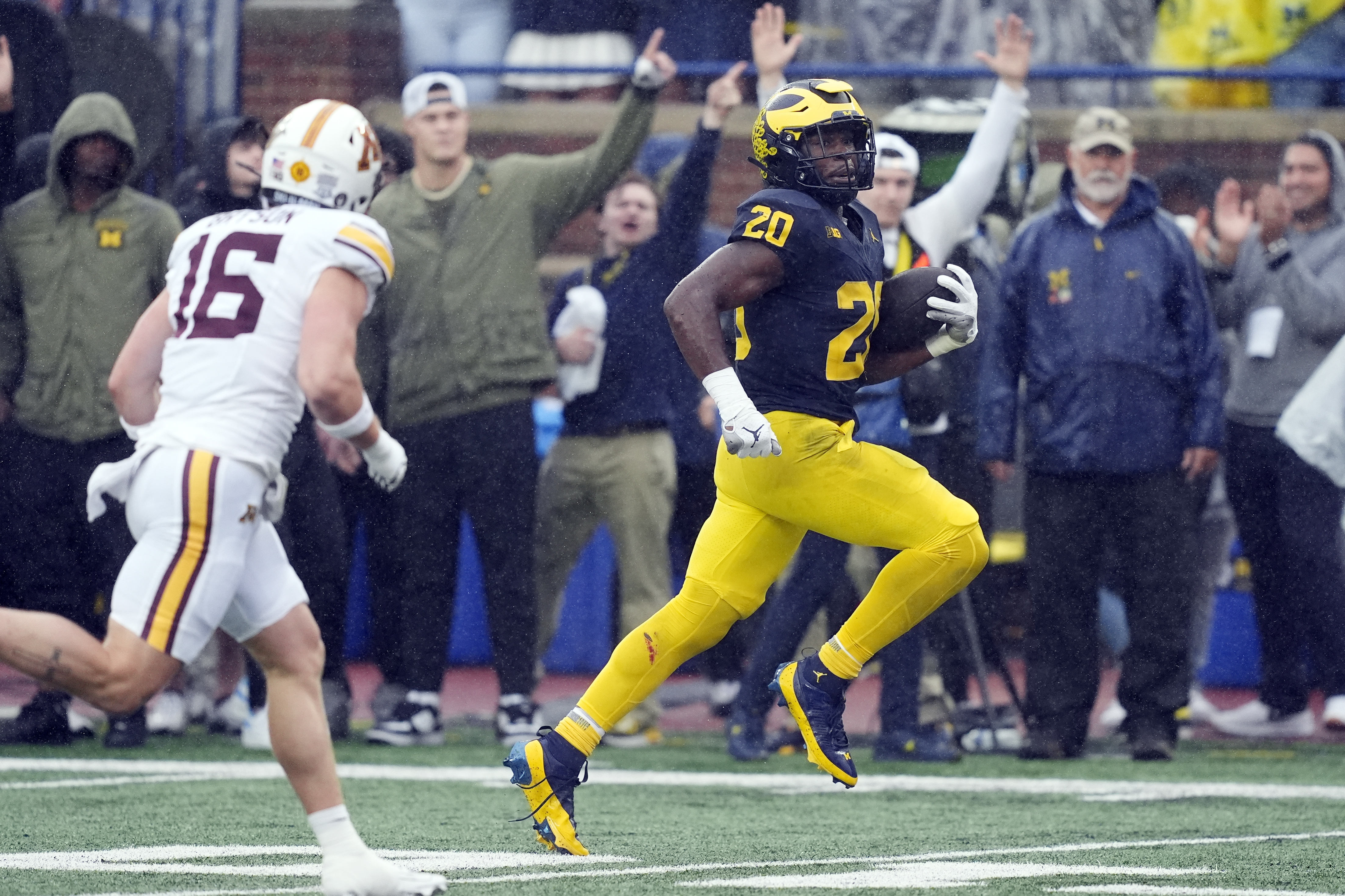 Michigan running back Kalel Mullings (20) pulls away from Minnesota Golden defensive back Coleman Bryson (16) for a 27-yard rushing touchdown during the first half of an NCAA college football game, Saturday, Sept. 28, 2024, in Ann Arbor, Mich. 