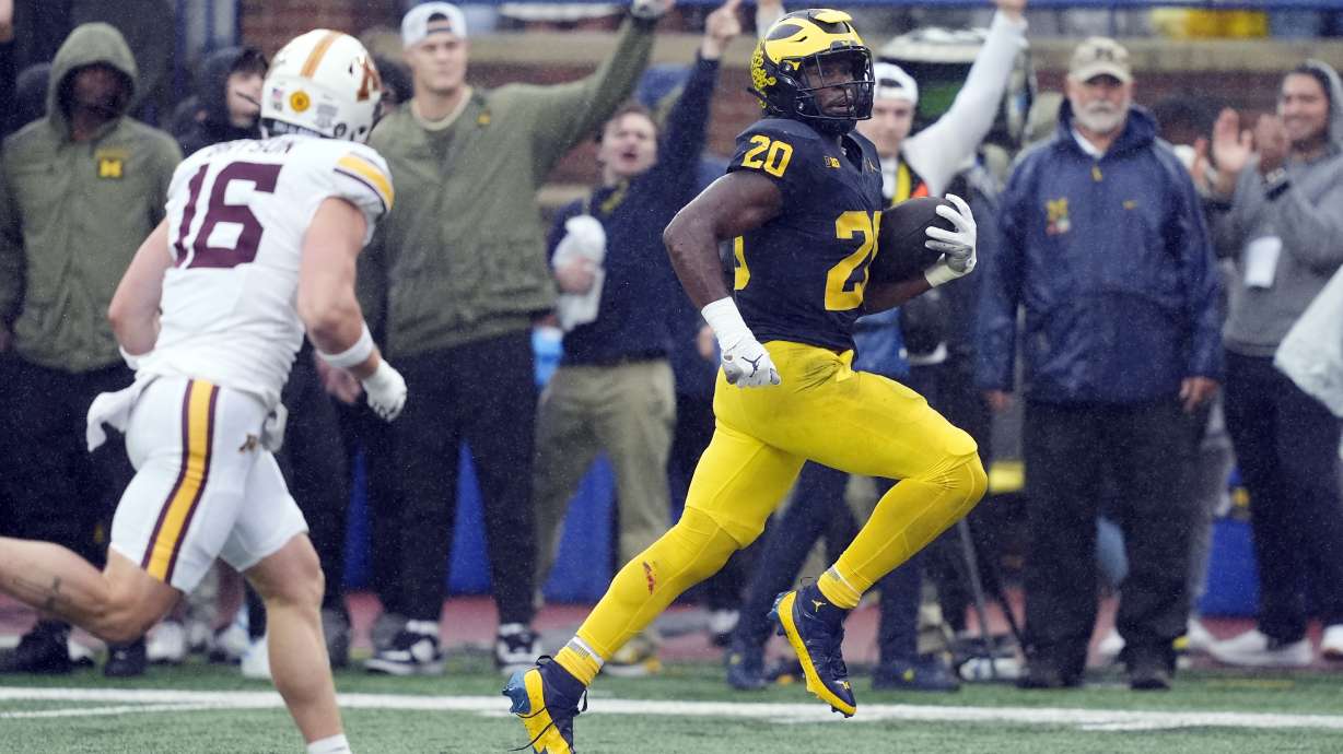 Michigan running back Kalel Mullings (20) pulls away from Minnesota Golden defensive back Coleman Bryson (16) for a 27-yard rushing touchdown during the first half of an NCAA college football game, Saturday, Sept. 28, 2024, in Ann Arbor, Mich.