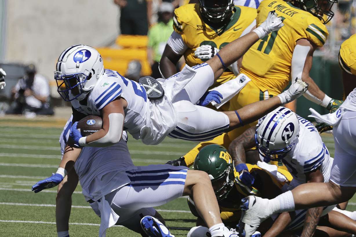 Brigham Young running back Enoch Nawahine leaps through the Baylor defense in the first half of an NCAA college football game, Saturday, Sept. 28, 2024, in Waco, Texas.