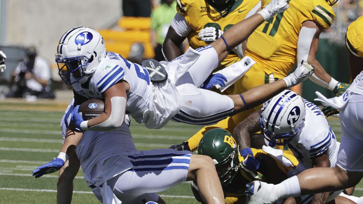 Brigham Young running back Enoch Nawahine leaps through the Baylor defense in the first half of an NCAA college football game, Saturday, Sept. 28, 2024, in Waco, Texas.