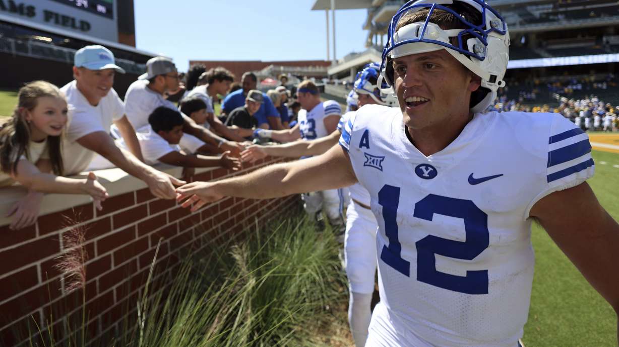 BYU quarterback Jake Retzlaff (12) celebrates with fans after a win over Baylor in an NCAA college football game Saturday, Sept. 28, 2024, in Waco, Texas.