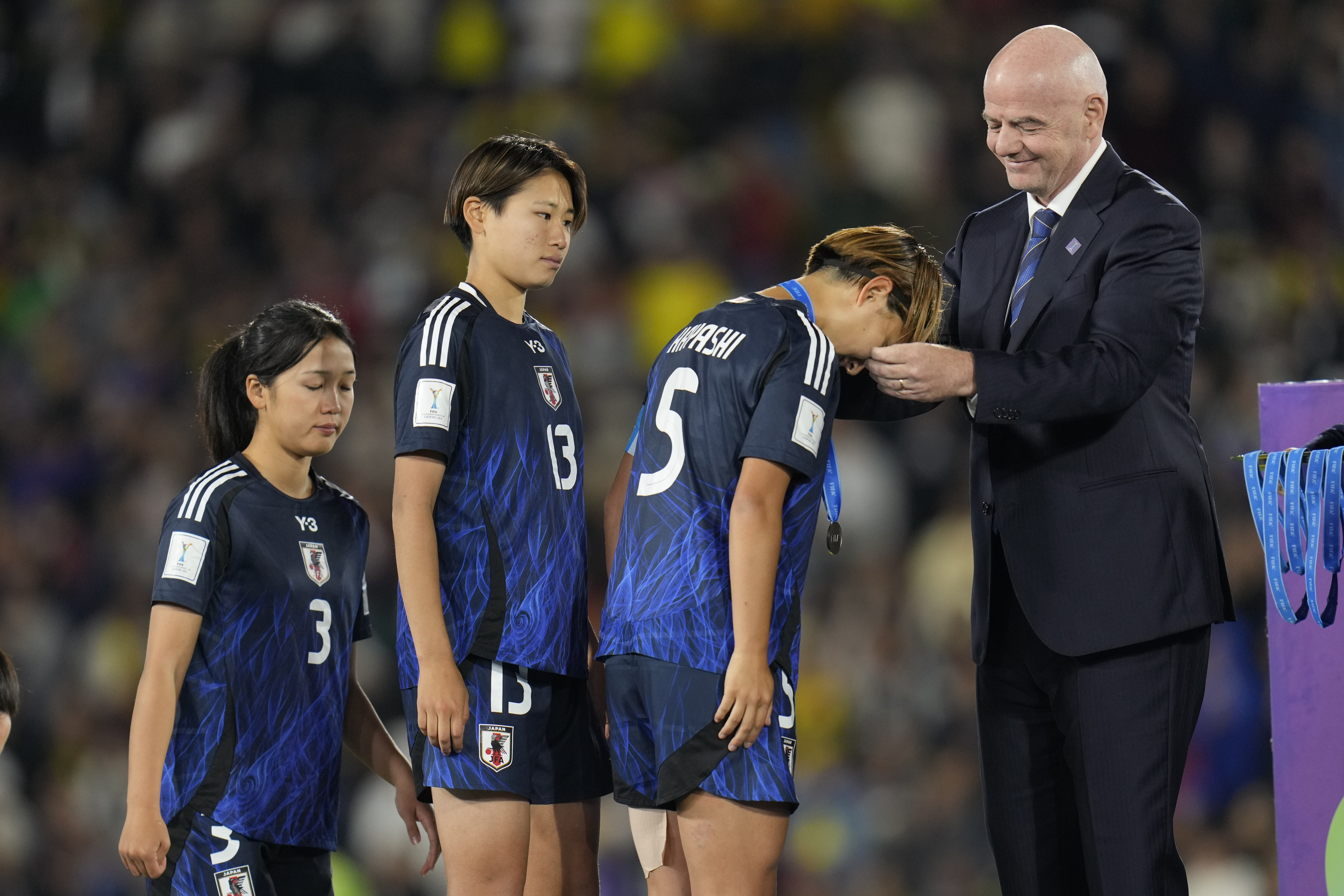 FIFA President Gianni Infantino, right, gives he second-place medal to Japan's Manaka Hayashi after her team lost the U-20 Women's World Cup final soccer match to North Korea at El Campin stadium in Bogota, Colombia, Sunday, Sept. 22, 2024.