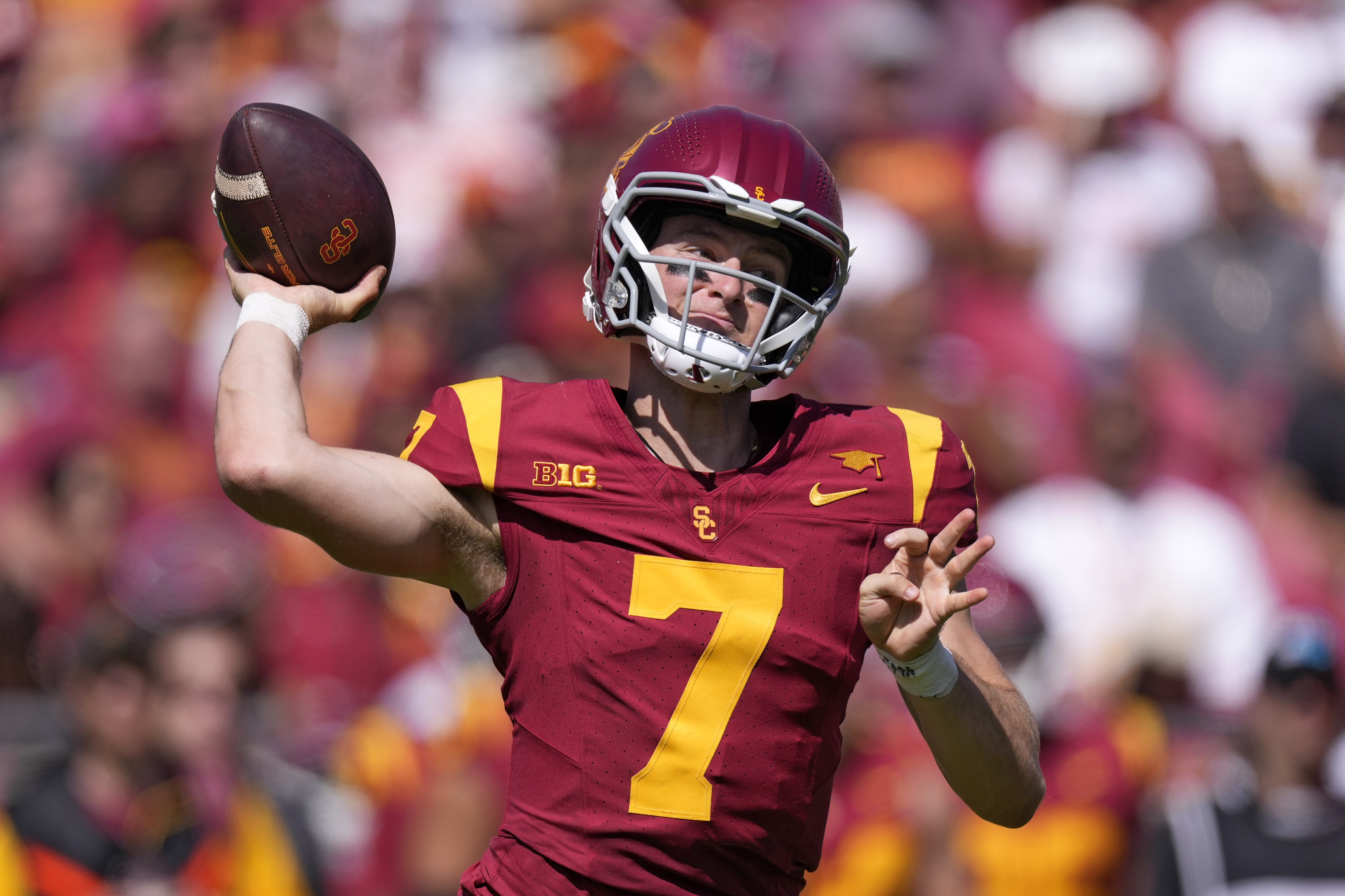 No. 13 USC rallies from a double-digit deficit in the second half and roars past Wisconsin, 38-21