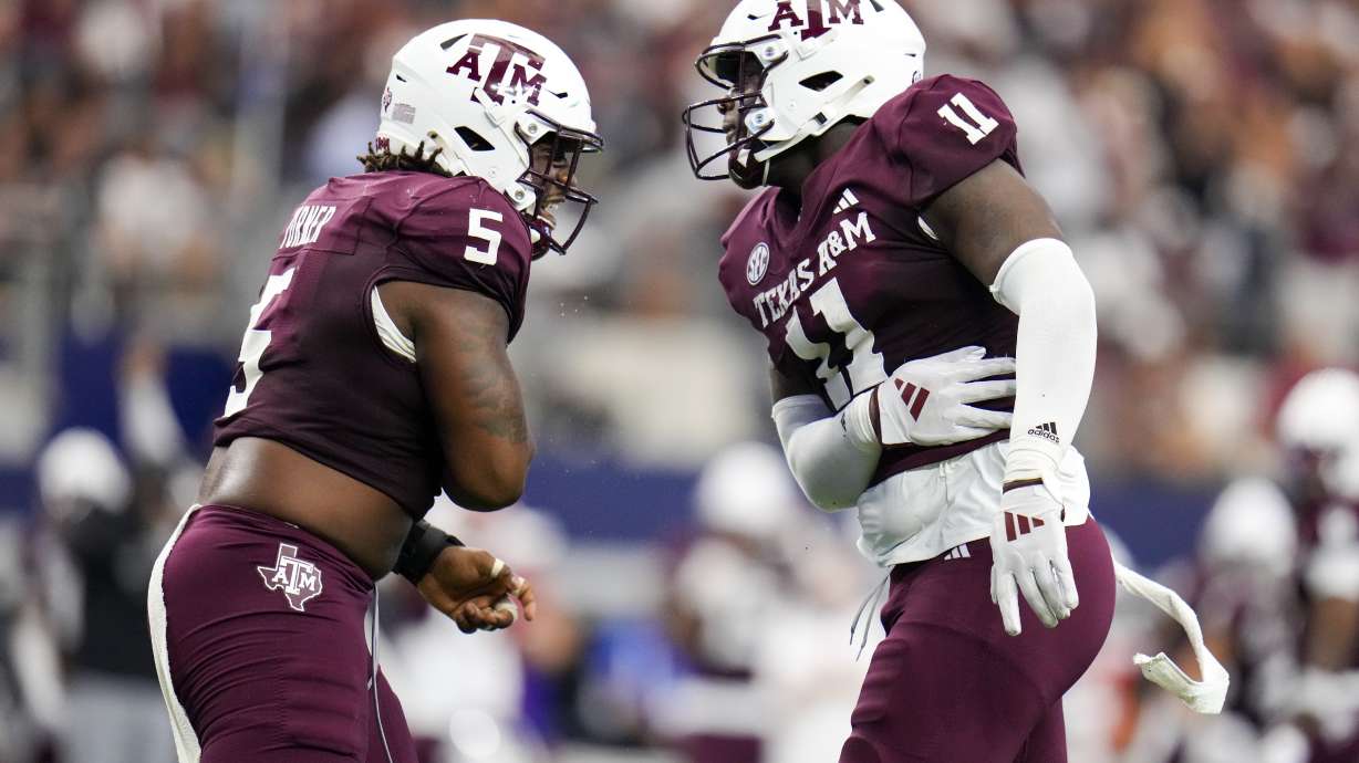 Texas A&M defensive lineman Shemar Turner, left, and defensive lineman Nic Scourton react after a tackle during the first half of an NCAA college football game against Arkansas, Saturday, Sept. 28, 2024, in Arlington, Texas.