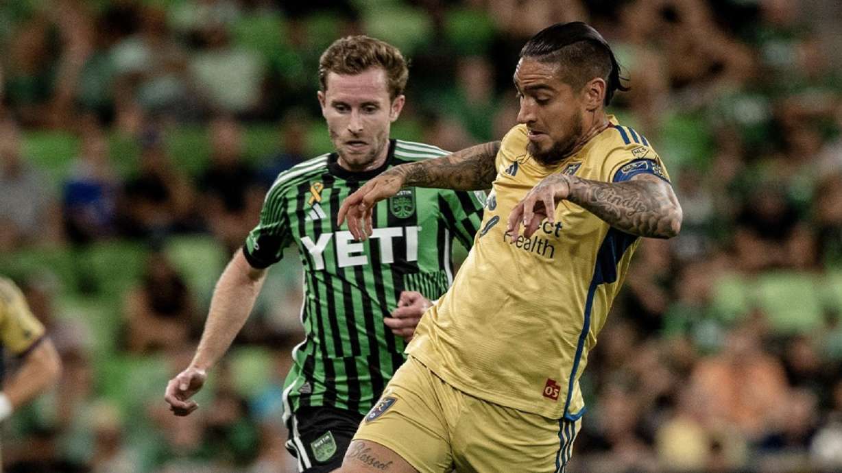Chicho Arango dribbles away from an Austin FC defender.