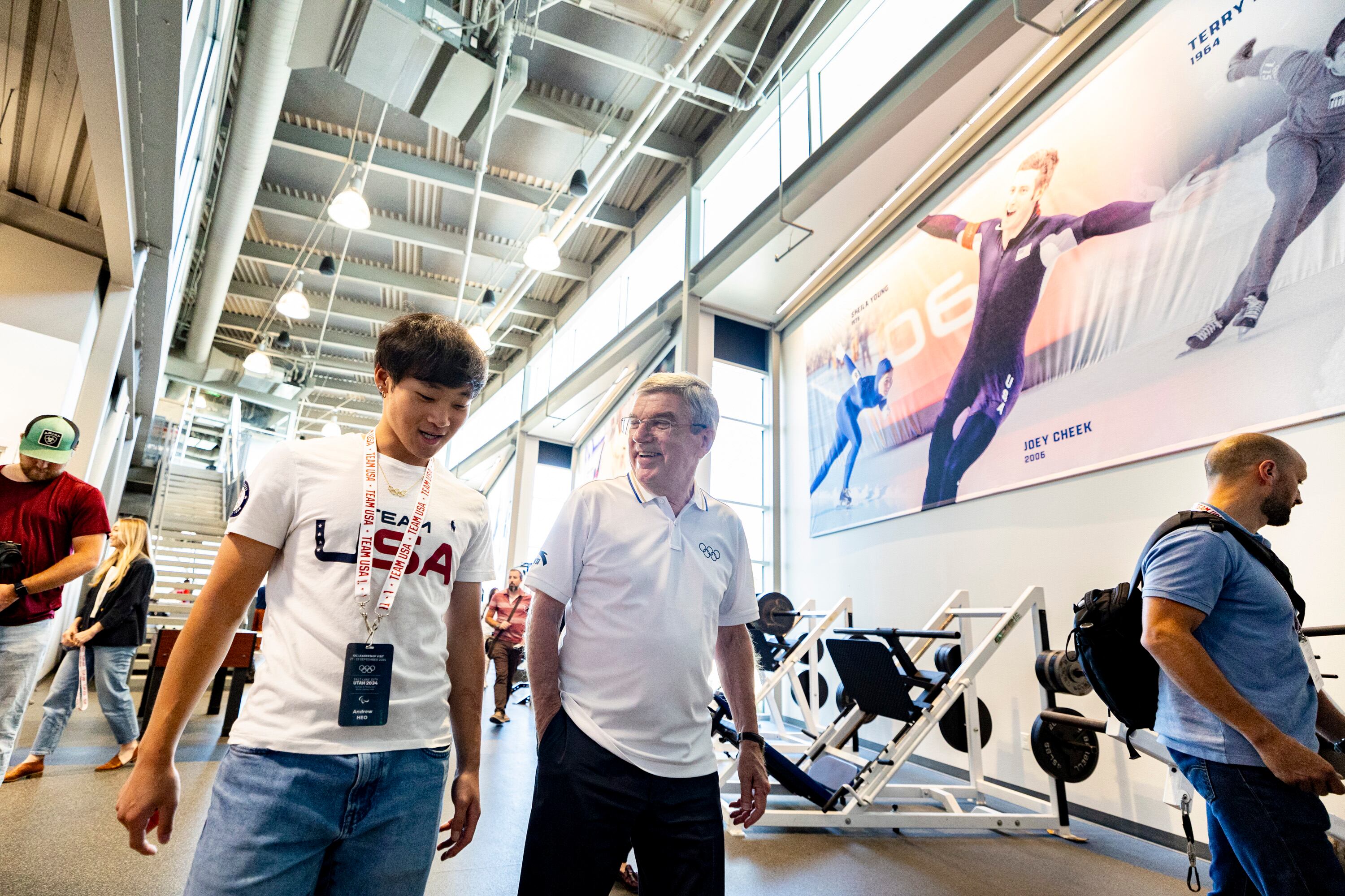 International Olympic Committee President Thomas Bach talks with Olympic speedskater Andrew Heo as they tour the U.S. Speedskating Speed Factory training center at the Utah Olympic Oval in Kearns on Saturday.