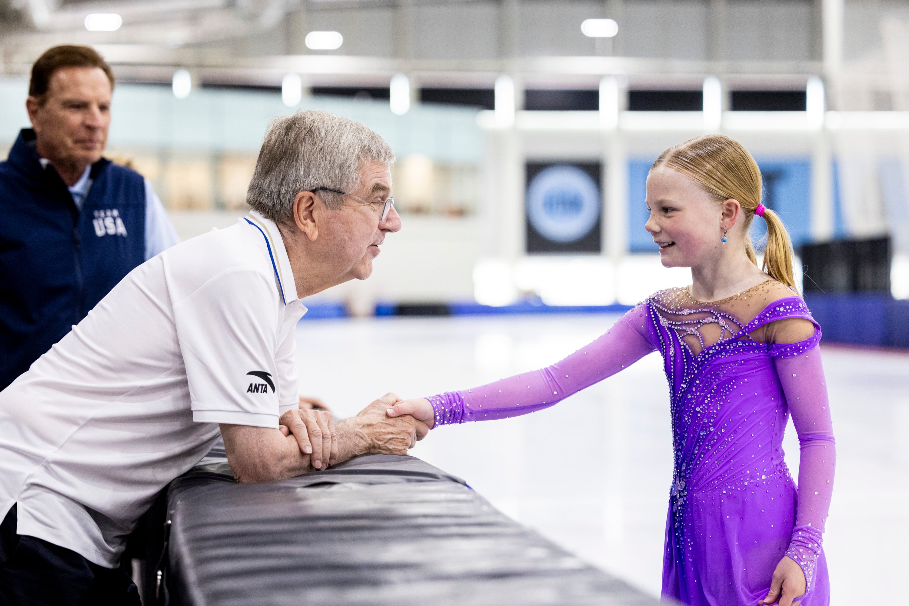 International Olympic Committee President Thomas Bach shakes hands with figure skater Annabelle Atkinson, 10, of Salt Lake City, as they talk at the Utah Olympic Oval in Kearns on Saturday.