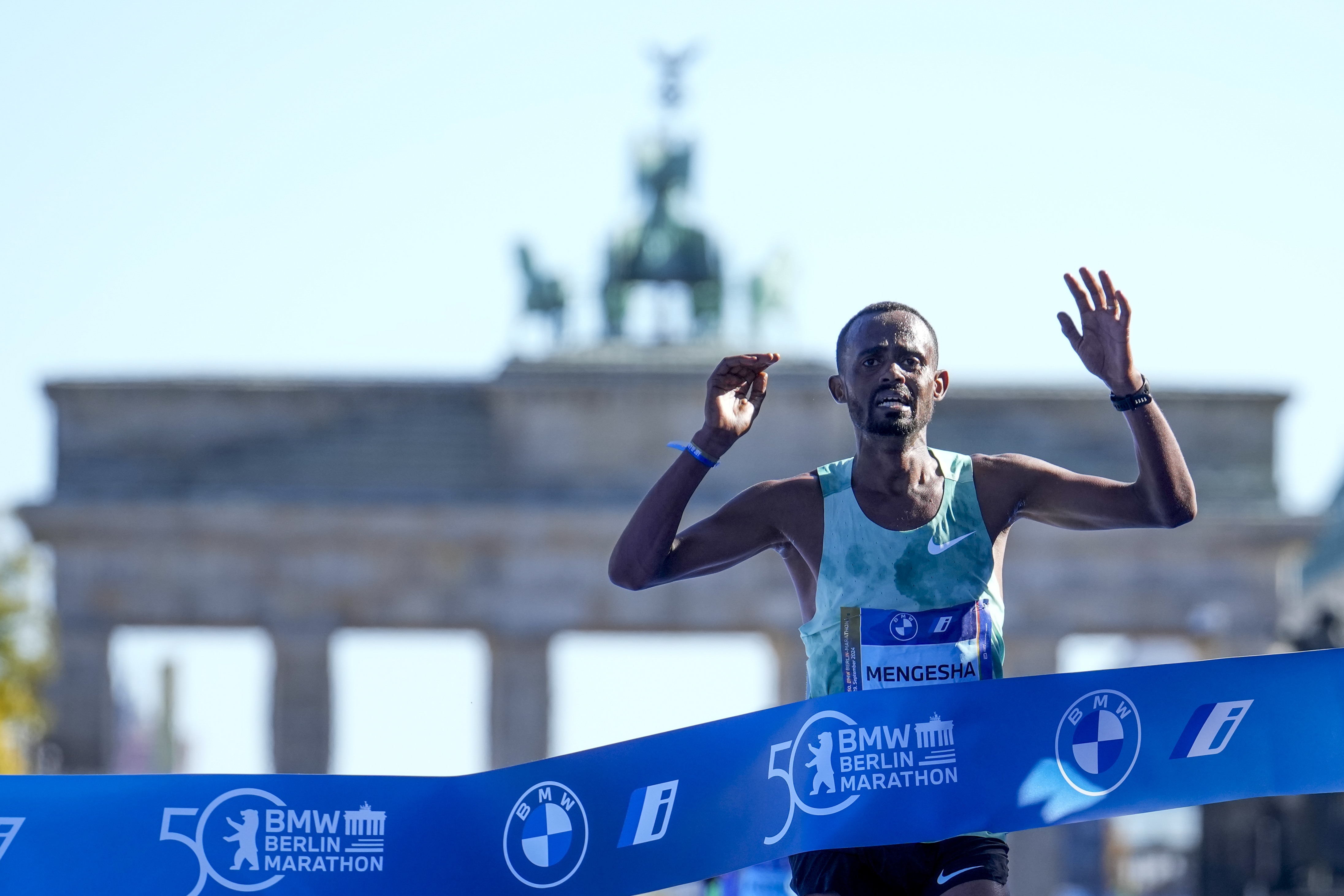 Milkesa Mengesha from Ethiopia celebrates as he crosses the finish line to win the men's division of the Berlin Marathon in Berlin, Germany, Sunday, Sept. 29, 2024. 