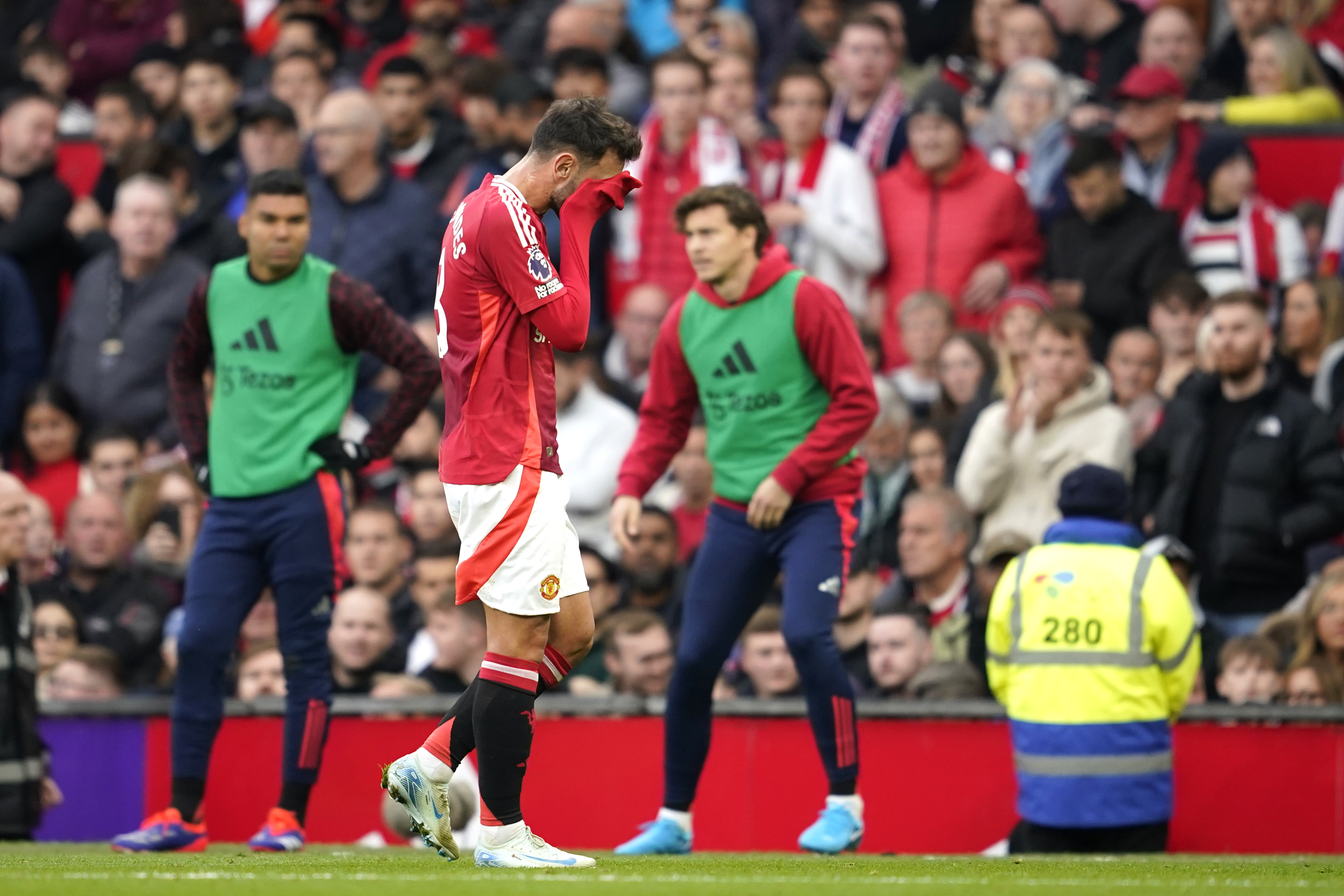 Manchester United's Bruno Fernandes walks off the pitch after receiving the red card for a foul during the English Premier League soccer match between Manchester United and Tottenham Hotspur at Old Trafford stadium in Manchester, England, Sunday, Sept. 29, 2024.