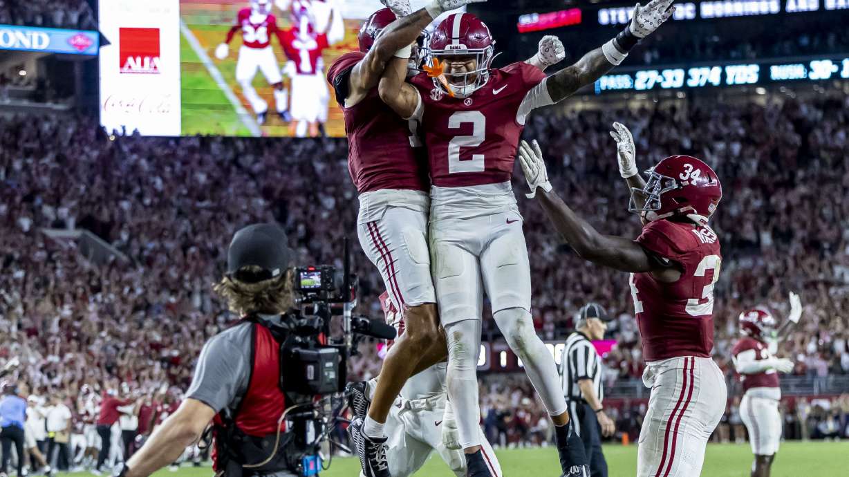 Alabama defensive back Domani Jackson, left, celebrates with defensive back Zabien Brown (2) and linebacker Que Robinson (34) after Brown intercepted a pass in the final minute during the second half of an NCAA college football game against Georgia, Saturday, Sept. 28, 2024, in Tuscaloosa, Ala.