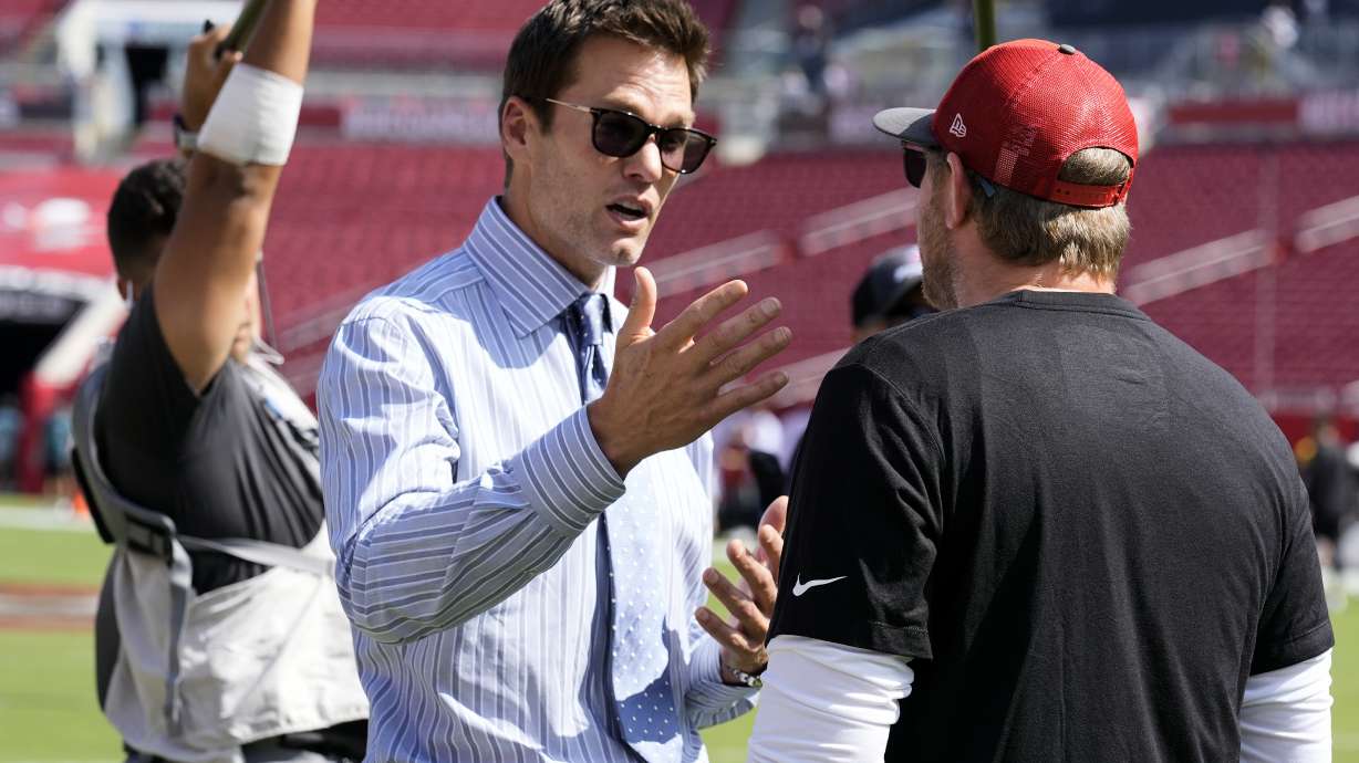Former quarterback Tom Brady, left, talks to Tampa Bay Buccaneers offensive coordinator Liam Coen before an NFL football game between the Buccaneers and the Philadelphia Eagles Sunday, Sept. 29, 2024, in Tampa, Fla.