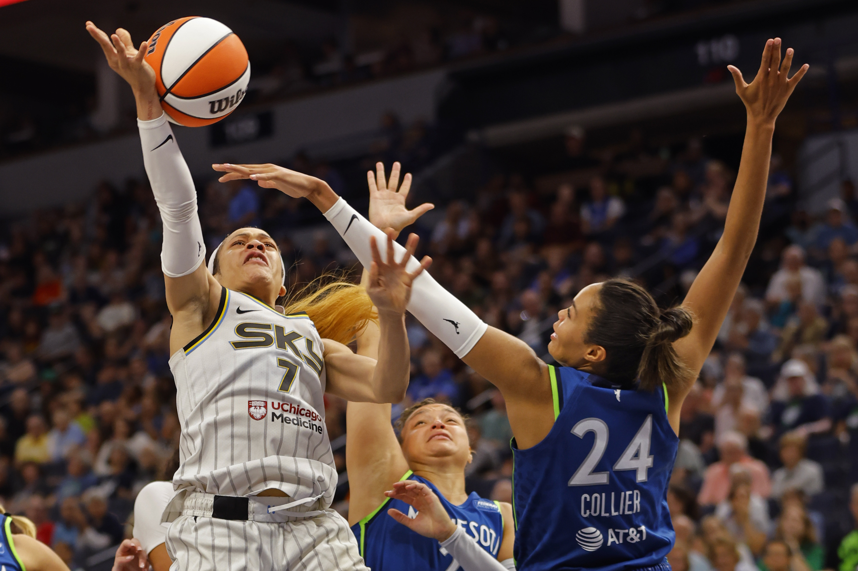 Chicago Sky guard Chennedy Carter (7) goes to the basket as Minnesota Lynx guard Kayla McBride, center, and forward Napheesa Collier (24) guard against her in the third quarter of a WNBA basketball game Friday, Sept. 13, 2024, in Minneapolis. 