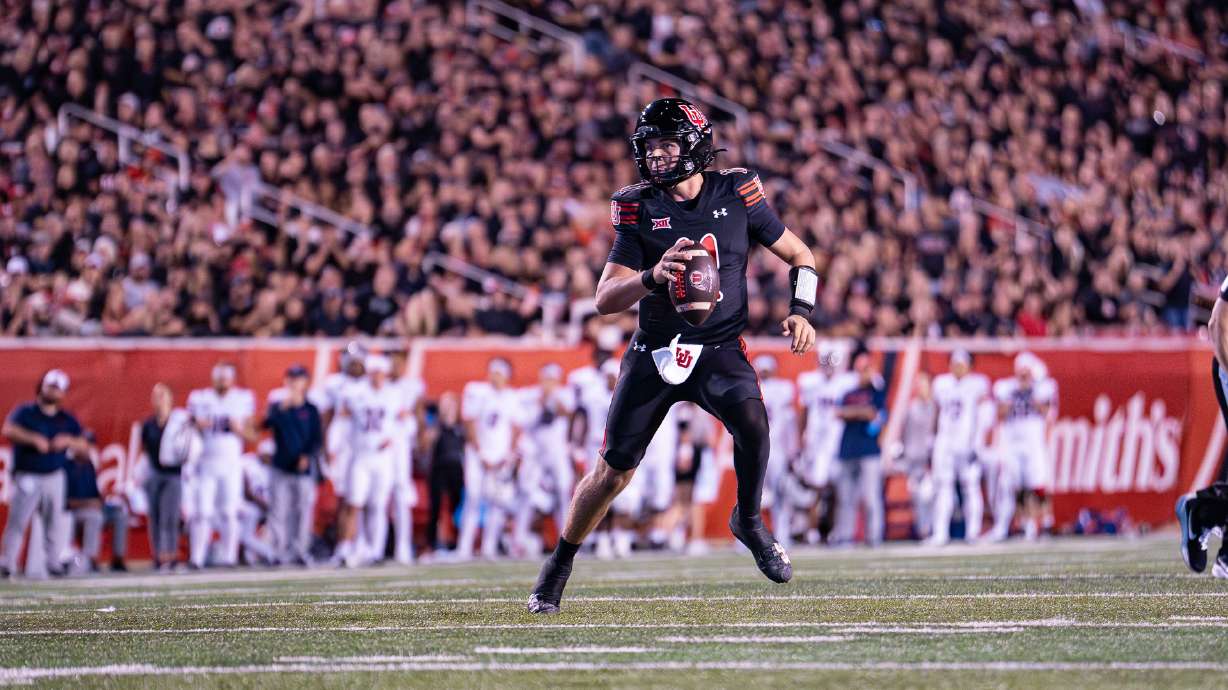 Utah quarterback Isaac Wilson rolls out of the pocket against Arizona in a game at Rice-Eccles Stadium in Salt Lake City on Sept. 28, 2024.