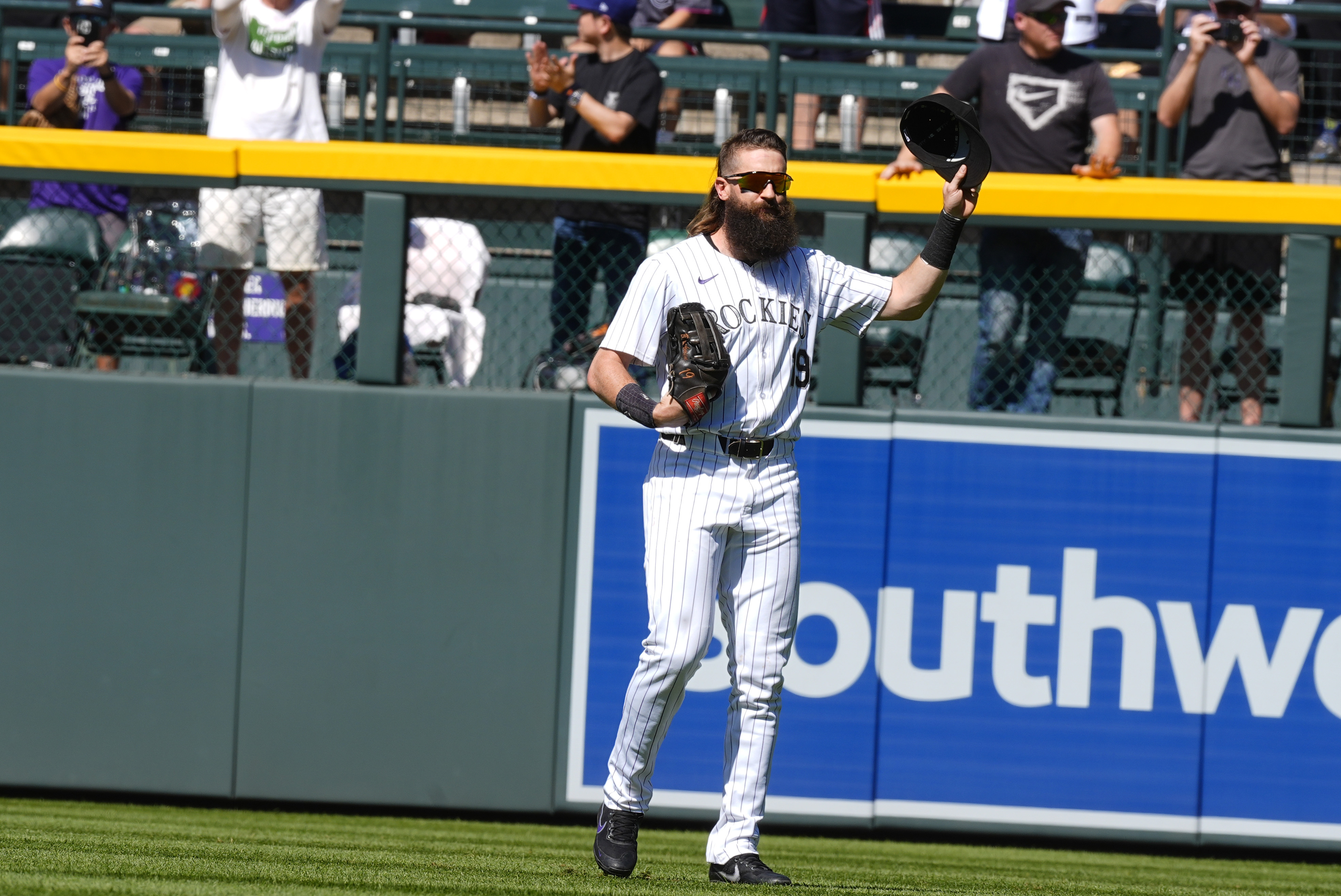Colorado Rockies center fielder Charlie Blackmon acknowledges the crowd as he takes the field in the first inning of a baseball game against the Los Angeles Dodgers, Sunday, Sept. 29, 2024, in Denver.