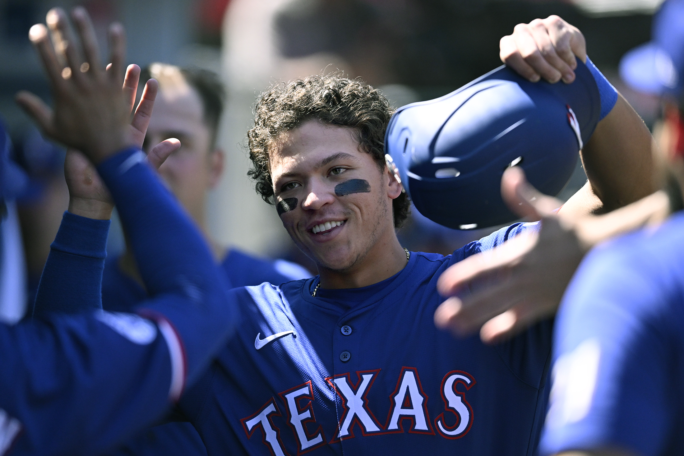 Texas Rangers' Dustin Harris is congratulated for his RBI double during the seventh inning of a baseball game against the Los Angeles Angels, Sunday, Sept. 29, 2024, in Anaheim, Calif. 