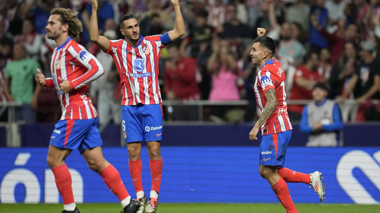 Atletico players celebrate a goal during the La Liga soccer match between Atletico Madrid and Real Madrid at the Metropolitano stadium in Madrid, Spain, Sunday, Sept. 29, 2024.