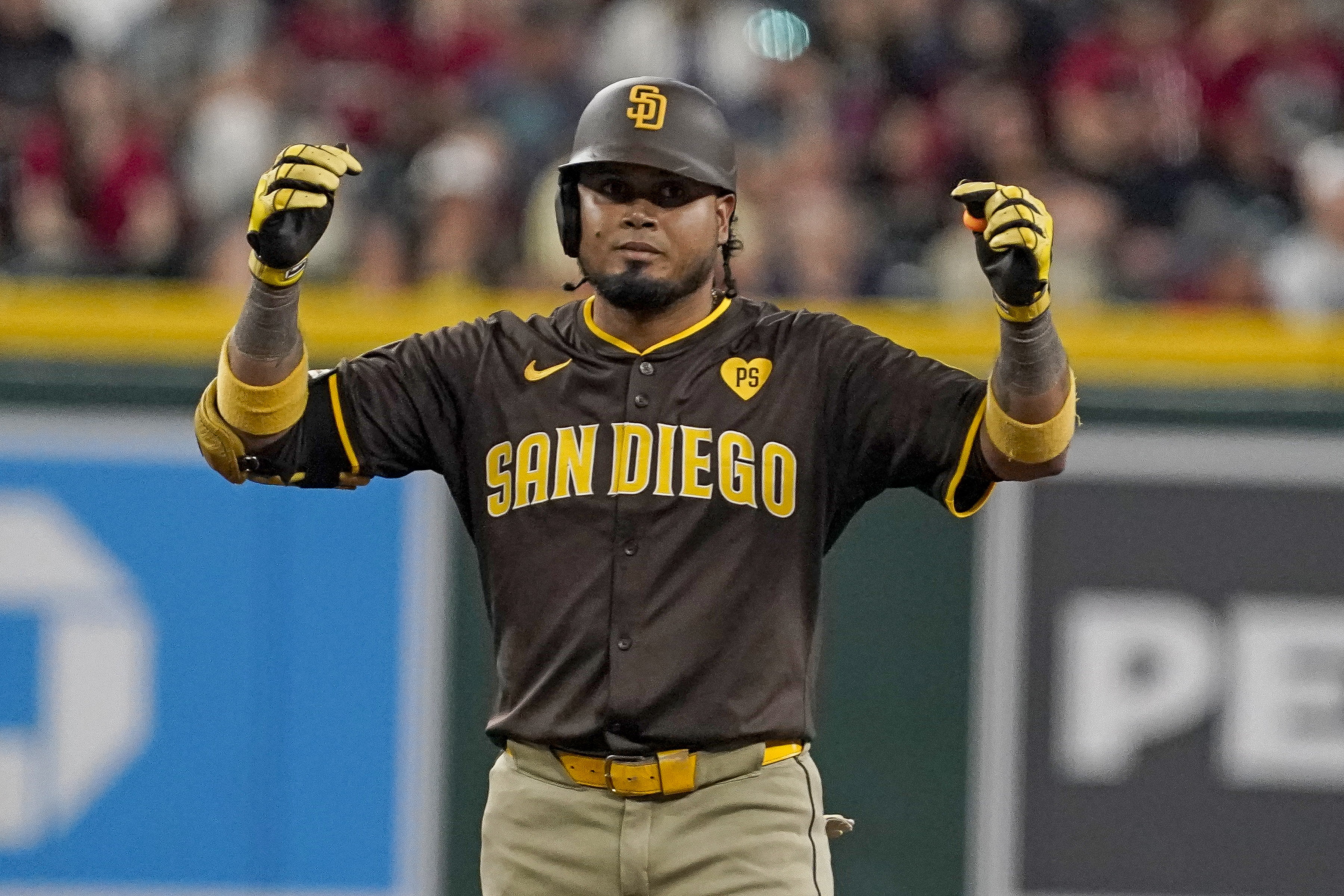 San Diego Padres' Luis Arraez celebrates after his double against the Arizona Diamondbacks during the sixth inning of a baseball game, Sunday, Sept. 29, 2024, in Phoenix. 