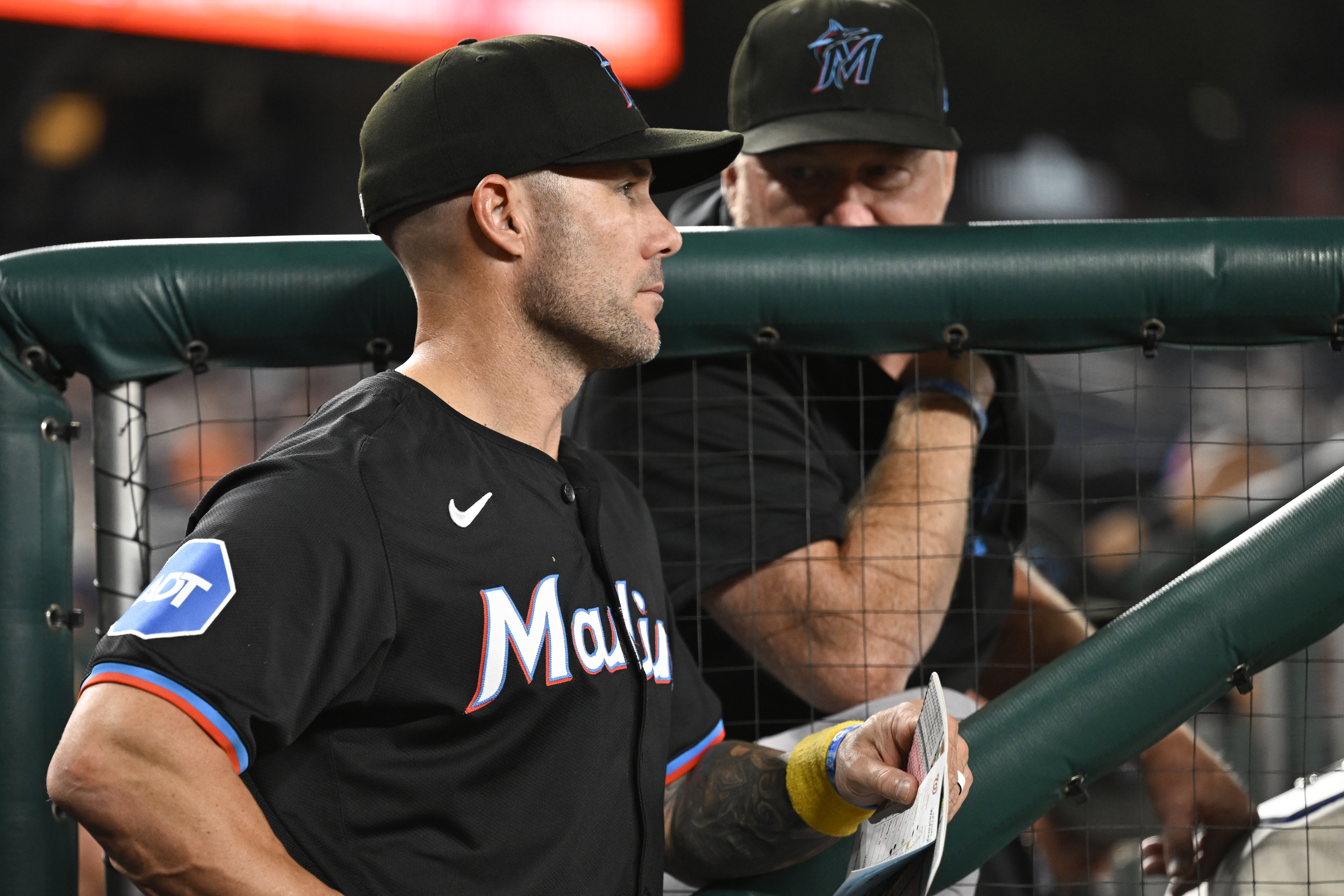 Miami Marlins manager Skip Schumaker, left, listens to Marlins pitching coach Mel Stottlemyre, right, in the dugout during the sixth inning of a baseball game against the Washington Nationals, Thursday, Sept. 12, 2024, in Washington. 