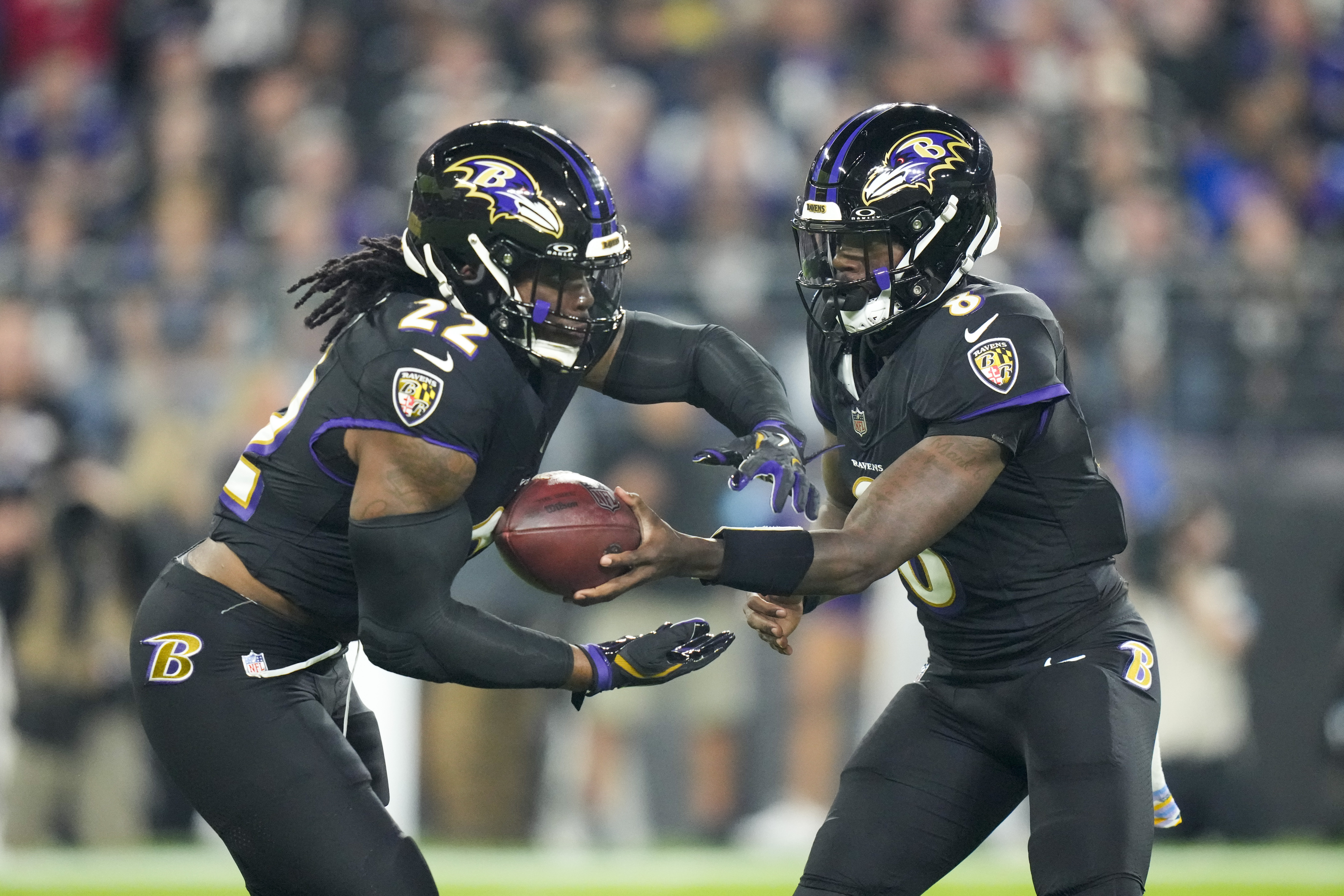 Baltimore Ravens running back Derrick Henry, left, takes a handoff from quarterback Lamar Jackson while running for a long touchdown against the Buffalo Bills during the first half of an NFL football game, Sunday, Sept. 29, 2024, in Baltimore.