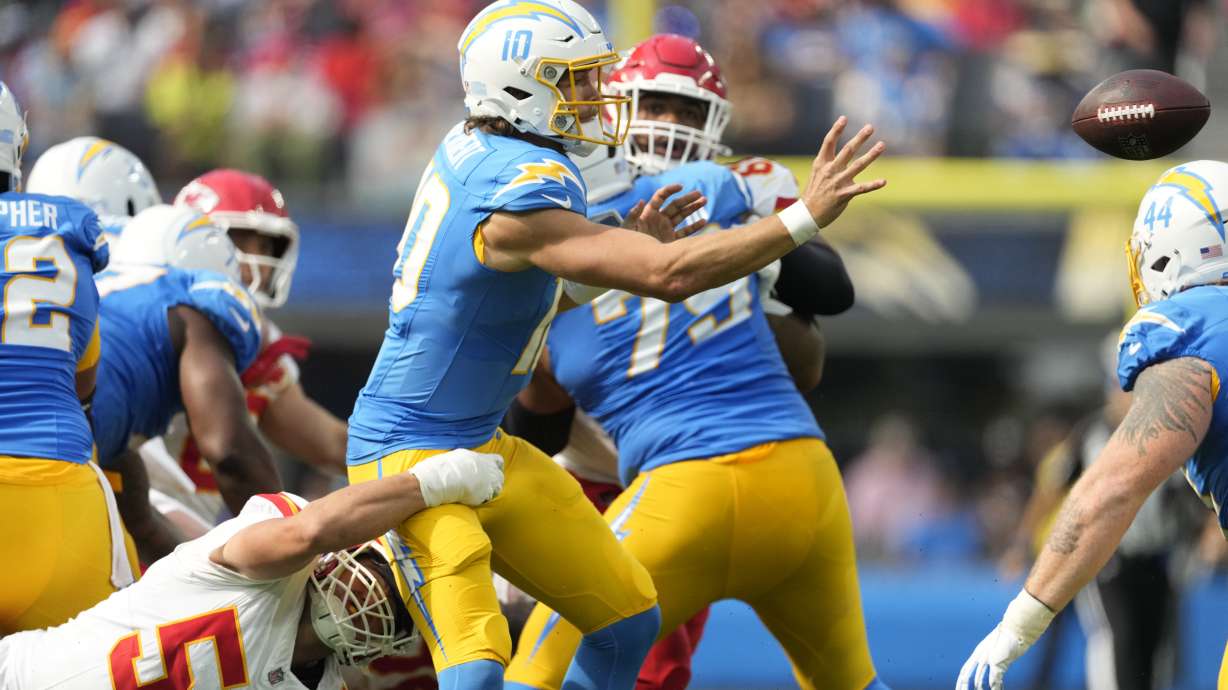 Los Angeles Chargers quarterback Justin Herbert (10) throws under pressure from Kansas City Chiefs defensive end George Karlaftis (56) during the second half of an NFL football game Sunday, Sept. 29, 2024, in Inglewood, Calif.