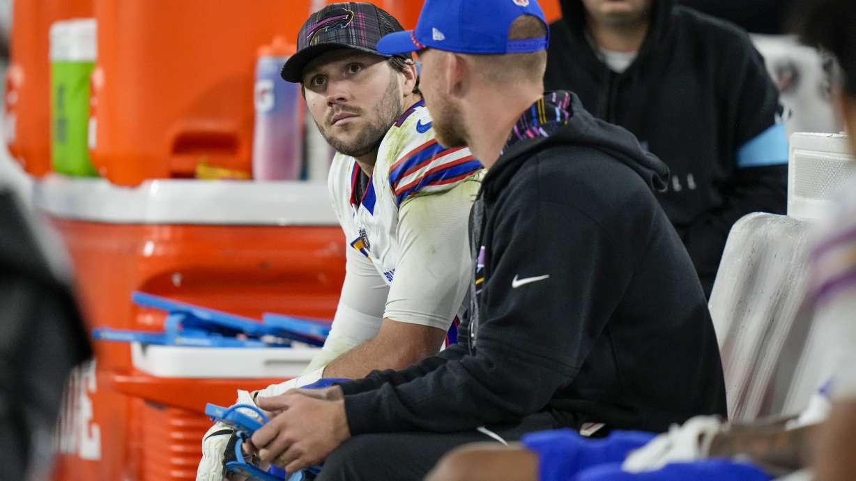 Buffalo Bills quarterback Josh Allen, left, sits on the bench after backup quarterback Mitchell Trubisky took over during the second half of an NFL football game against the Baltimore Ravens, Sunday, Sept. 29, 2024, in Baltimore.