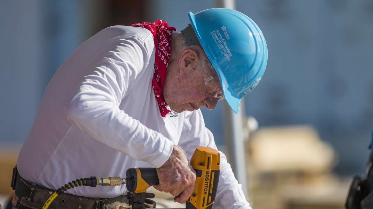 Former President Jimmy Carter works with other volunteers on site during the first day of the weeklong Jimmy & Rosalynn Carter Work Project, Aug. 27, 2018, in Mishawaka, Ind. Carter turns 100 on Tuesday.