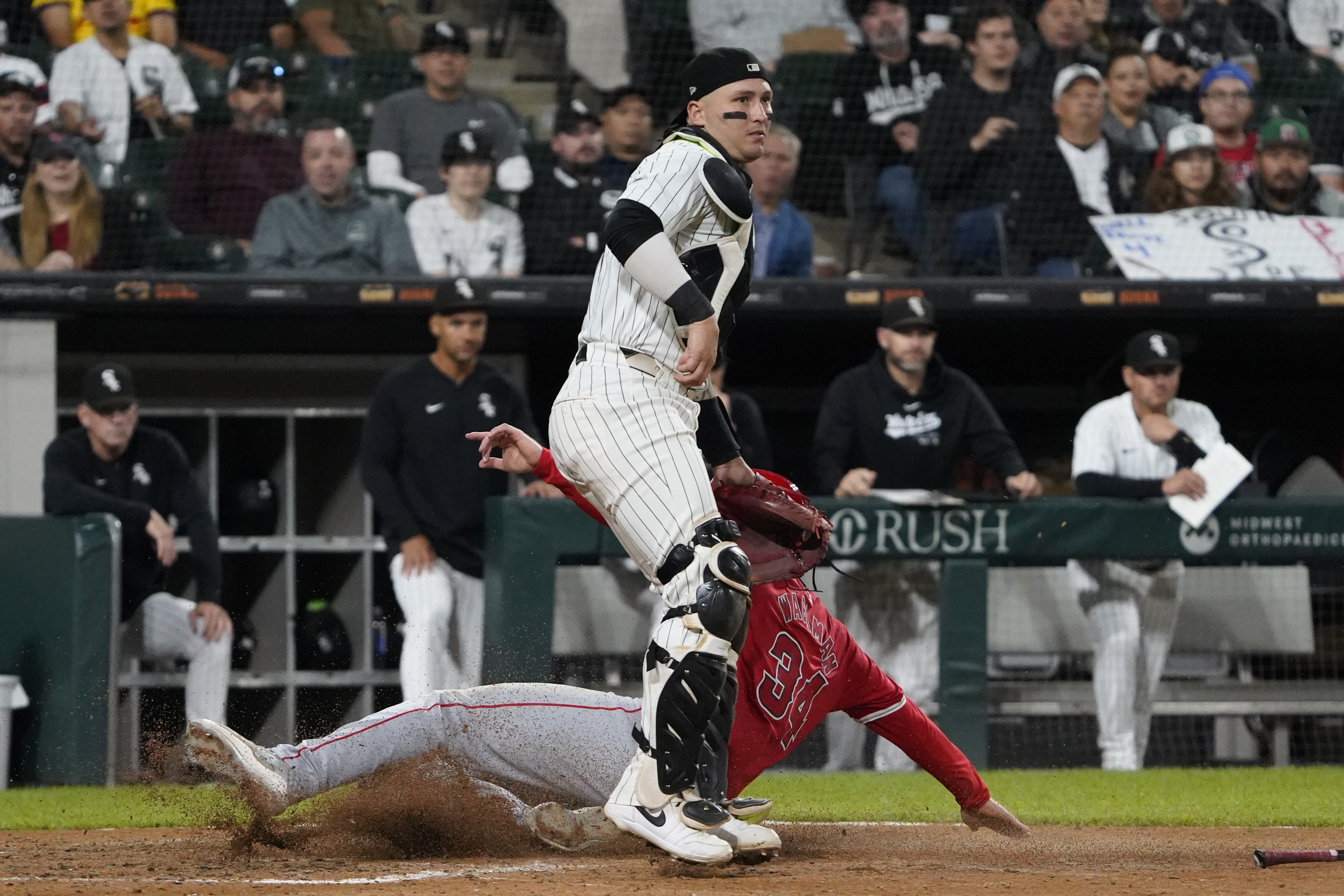 Los Angeles Angels' Eric Wagaman (34) is safe at home plate as Chicago White Sox catcher Korey Lee, right, stands nearby during eighth inning of a baseball game, Wednesday, Sept. 25, 2024, in Chicago. 