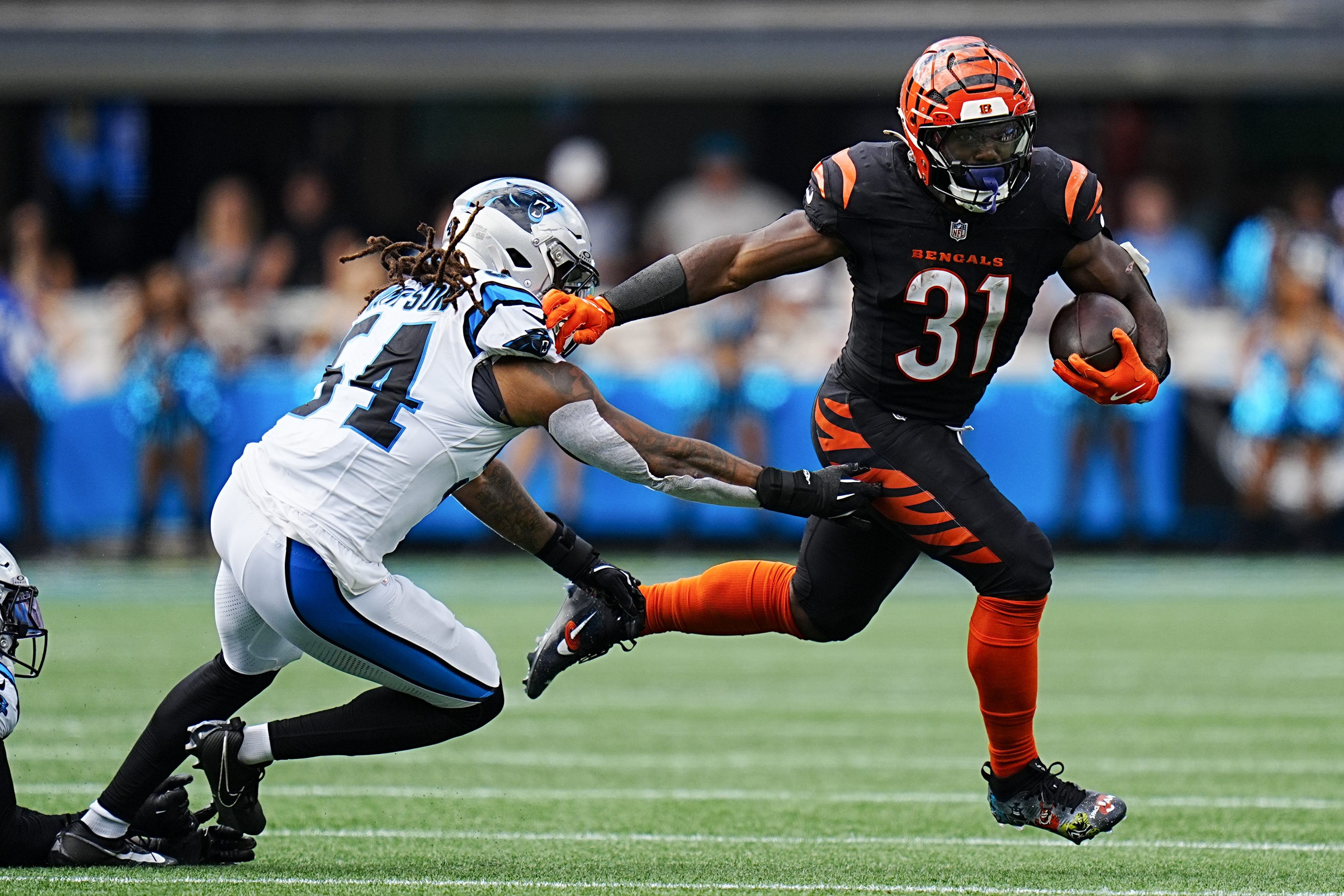Cincinnati Bengals running back Zack Moss runs past Carolina Panthers linebacker Shaq Thompson during the second half of an NFL football game, Sunday, Sept. 29, 2024, in Charlotte, N.C. 