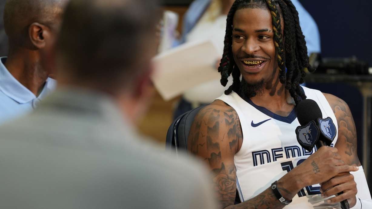 Memphis Grizzlies guard Ja Morant, left, sits for an interview during the NBA basketball team's media day Monday, Sept. 30, 2024 in Memphis, Tenn.