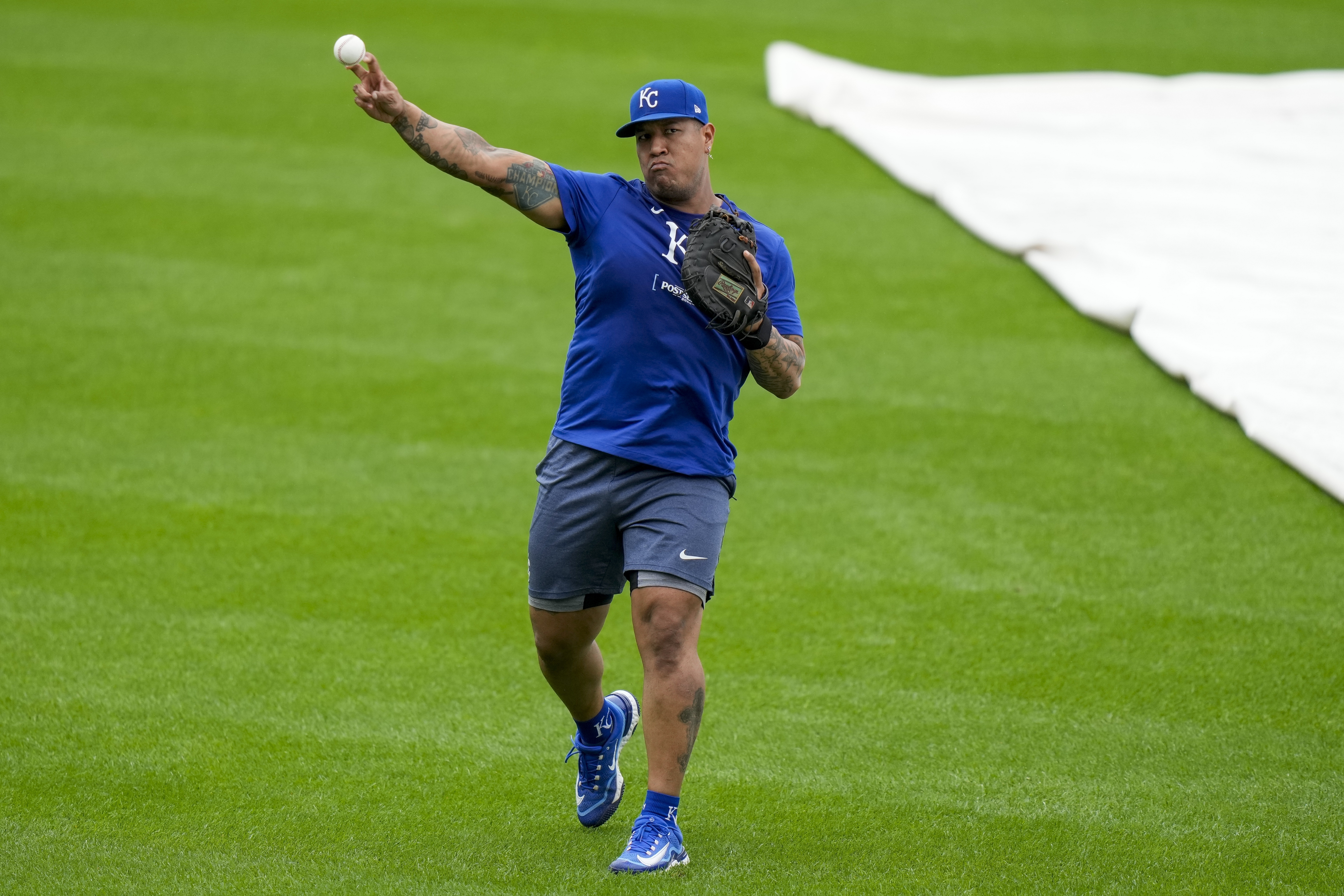 Kansas City Royals catcher Salvador Perez warms up during a baseball workout a day before the team's wild card playoff game against the Baltimore Orioles, Monday, Sept. 30, 2024, in Baltimore.