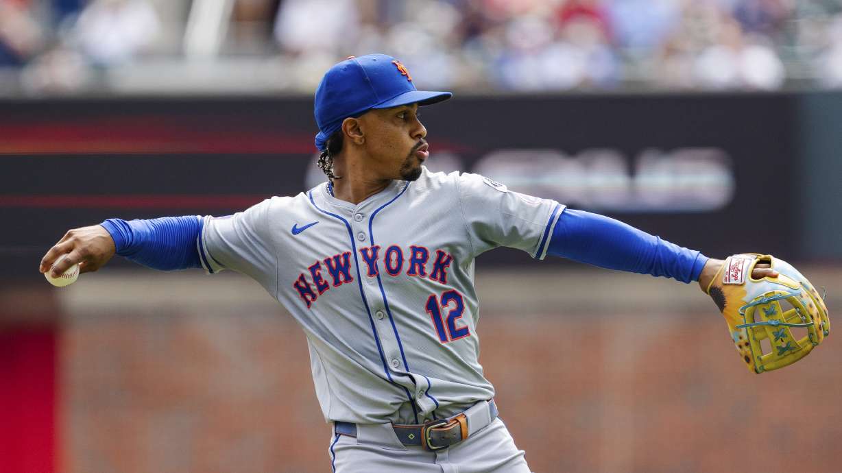 New York Mets shortstop Francisco Lindor throws to first base in the third inning of a baseball game against the New York Mets, Monday, Sept. 30, 2024, in Atlanta.