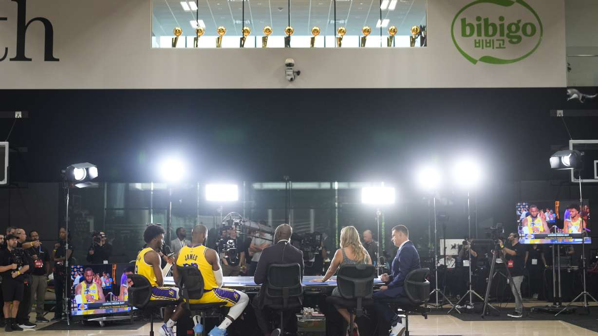 Los Angeles Lakers' LeBron James, second from left, and his son, Bronny James, sit for an interview during the NBA basketball team's media day in El Segundo, Calif., Monday, Sept. 30, 2024.
