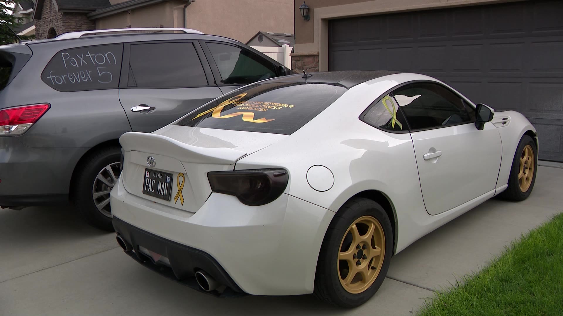 The two family cars with gold decals and “Paxton forever 5” is in honor of Paxton.