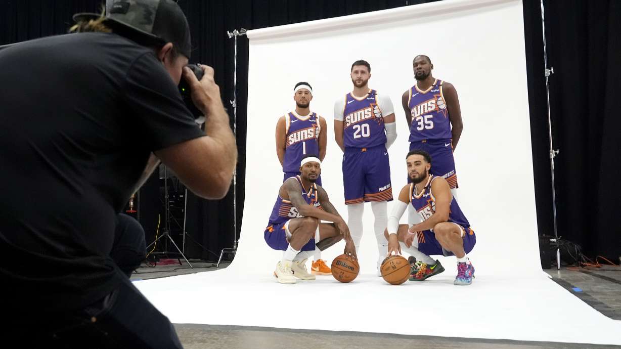 Phoenix Suns' Phoenix Suns guard Devin Booker (1), center Jusuf Nurkic (20), forward Kevin Durant (35), guard Bradley Beal, bottomleft, and guard Tyus Jones, bottom right, pose for a photo for team photographer Barry Gossage during an NBA basketball media day Monday, Sept. 30, 2024, in Phoenix.