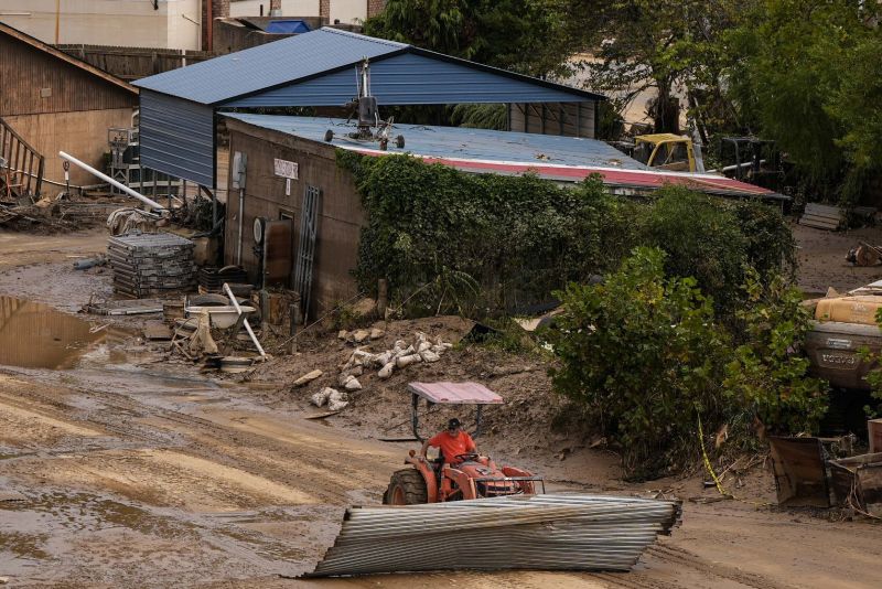 A worker moves debris in the aftermath of Hurricane Helene, Monday in Asheville, N.C.