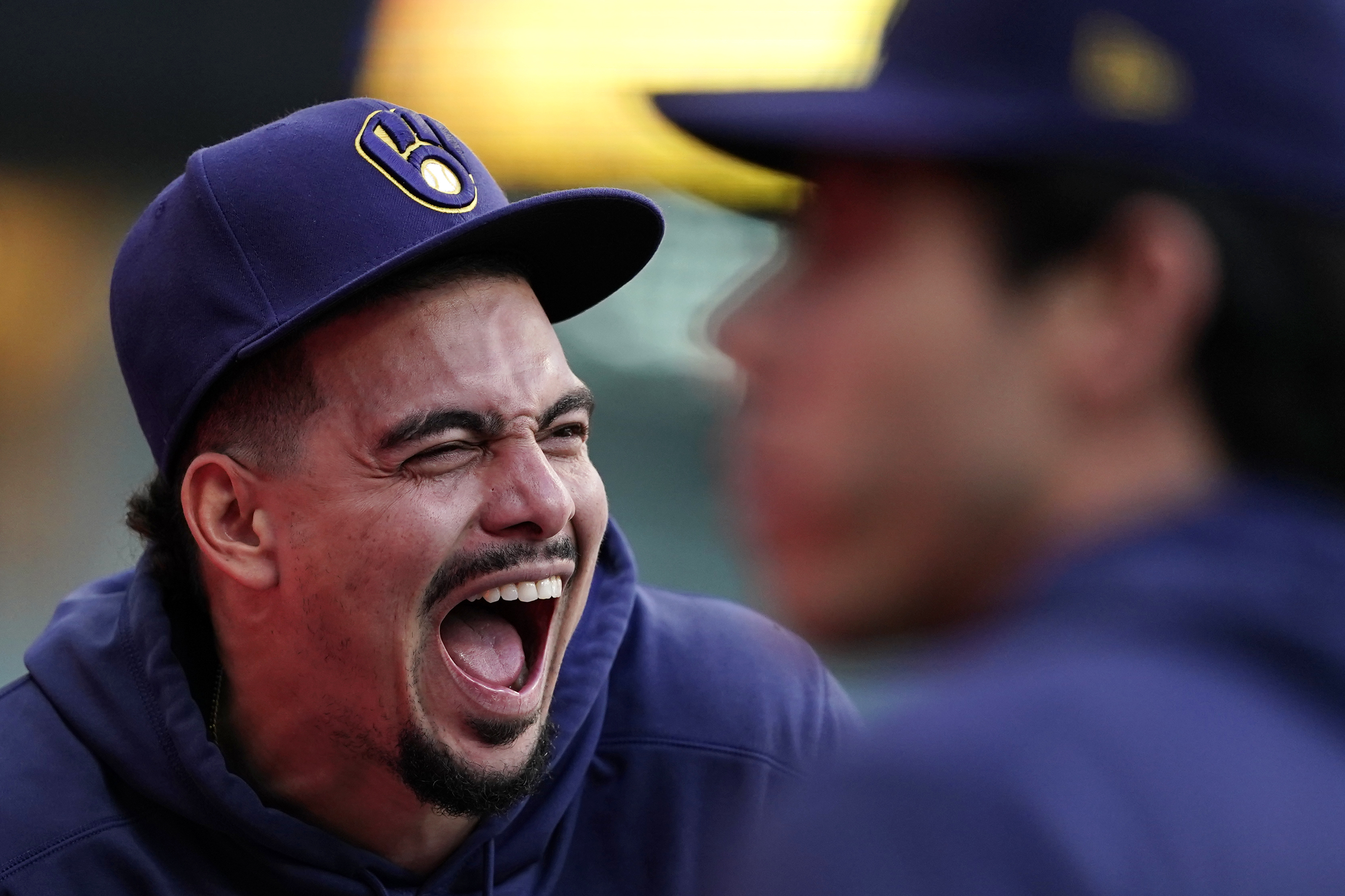 Milwaukee Brewers' Willy Adames, left, laughs from the dugout during the eighth inning of a baseball game against the New York Mets, Sunday, Sept. 29, 2024, in Milwaukee. 
