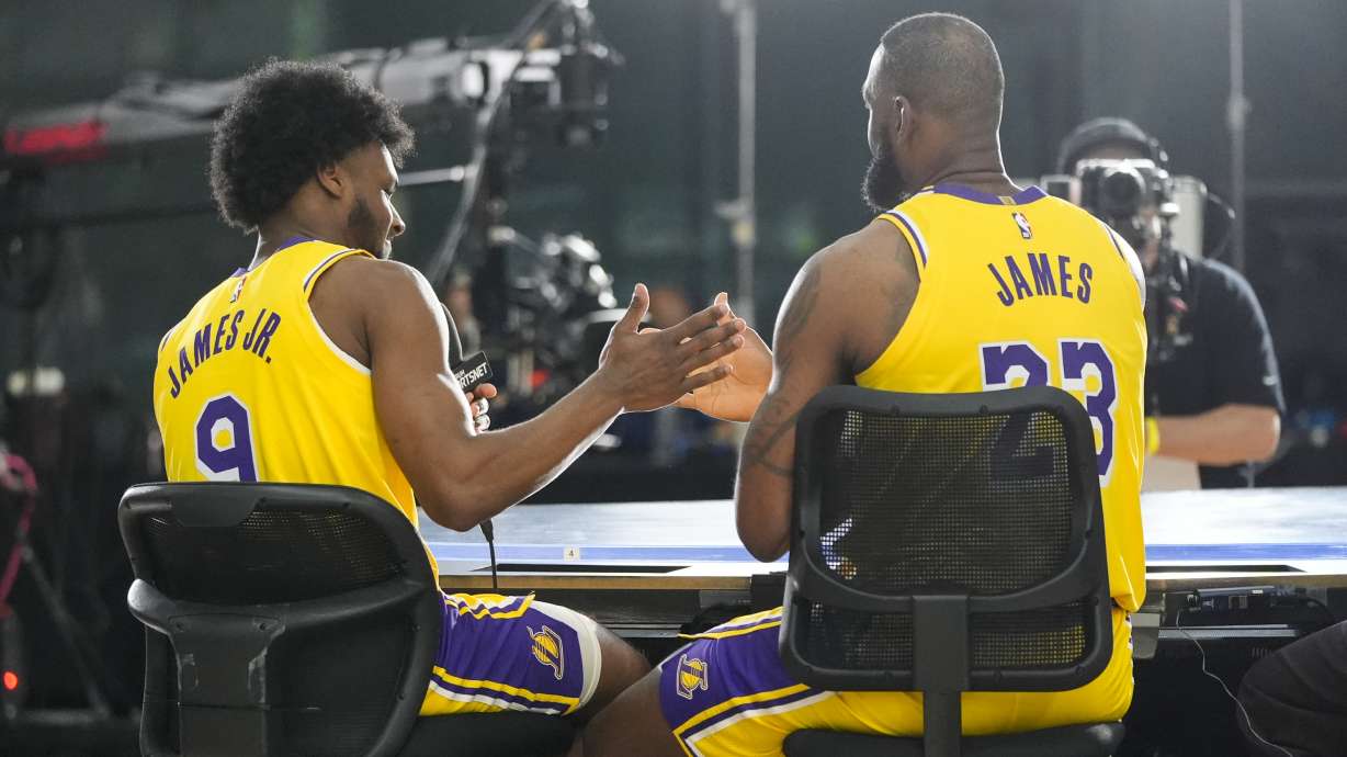 Los Angeles Lakers' LeBron James, right, and his son, Bronny James Jr, shake hands after an interview during the NBA basketball team's media day in El Segundo, Calif., Monday, Sept. 30, 2024.