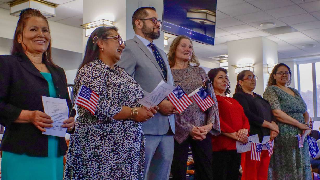 Seven of the nine people who took the oath of naturalization to become U.S. citizens in Ogden on Monday.