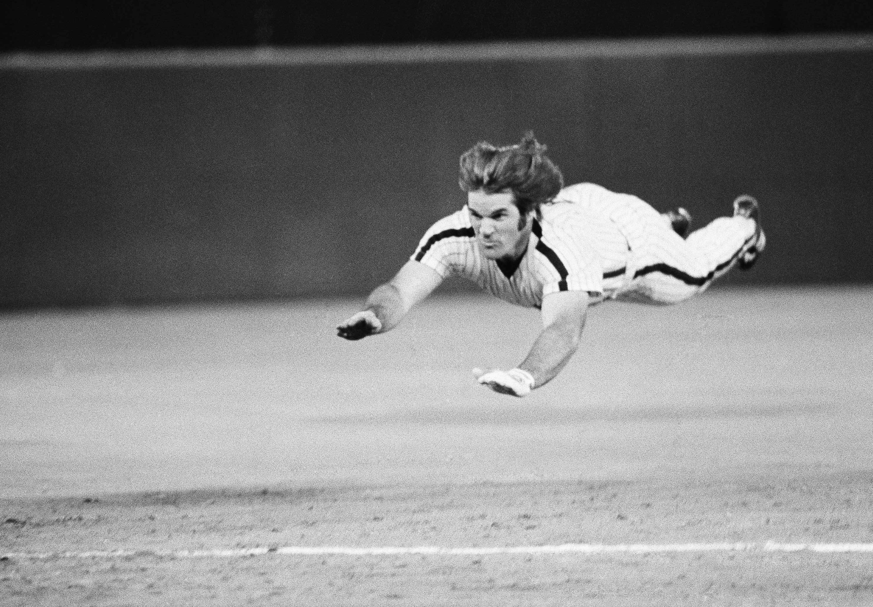 FILE - Philadelphia Phillies' Pete Rose slides to third base during a baseball game against the New York Mets in Philadelphia, June 3, 1981. 