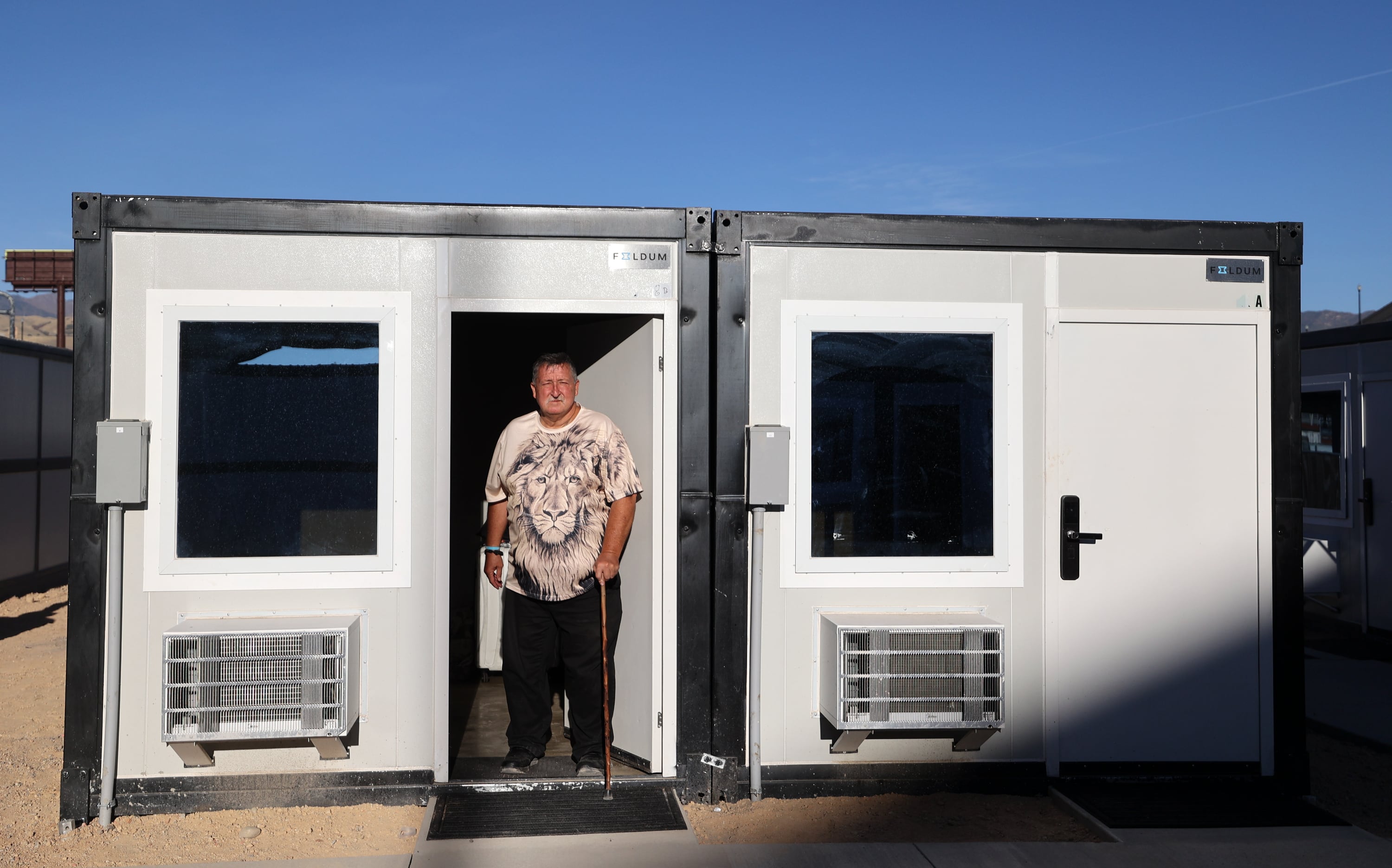 Steven Malia poses for a photo in his unit at the Microshelter Community, operated by Switchpoint, in Salt Lake City on Monday.