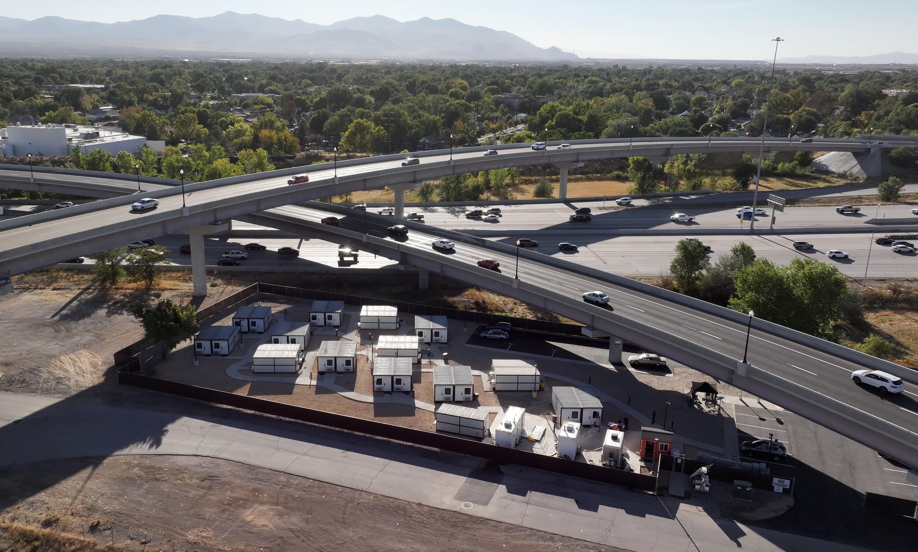 The Microshelter Community, operated by Switchpoint, is pictured between the highway and overpasses in Salt Lake City on Monday.