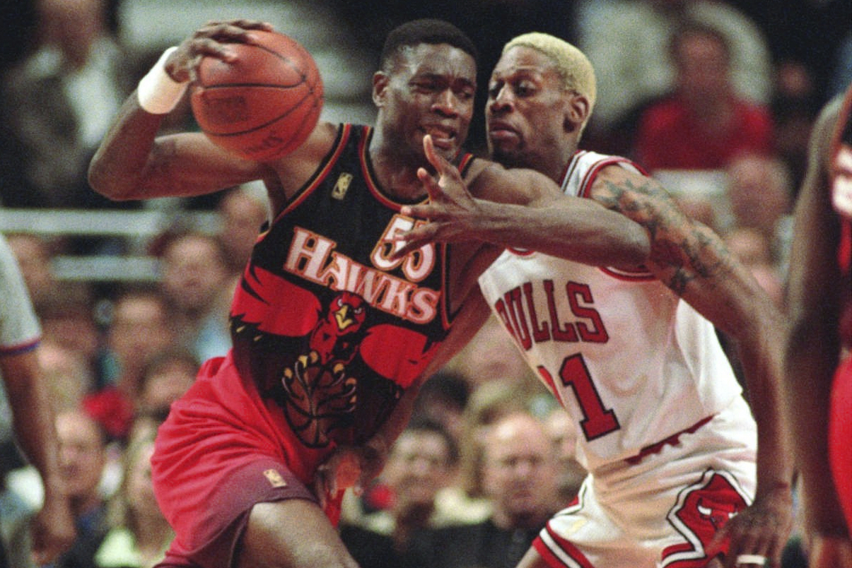 FILE - The Atlanta Hawks' Dikembe Mutombo, left, drives to the hoop against the Chicago Bulls' Dennis Rodman during the second quarter of their playoff game Thursday, May 8, 1997, in Chicago. 