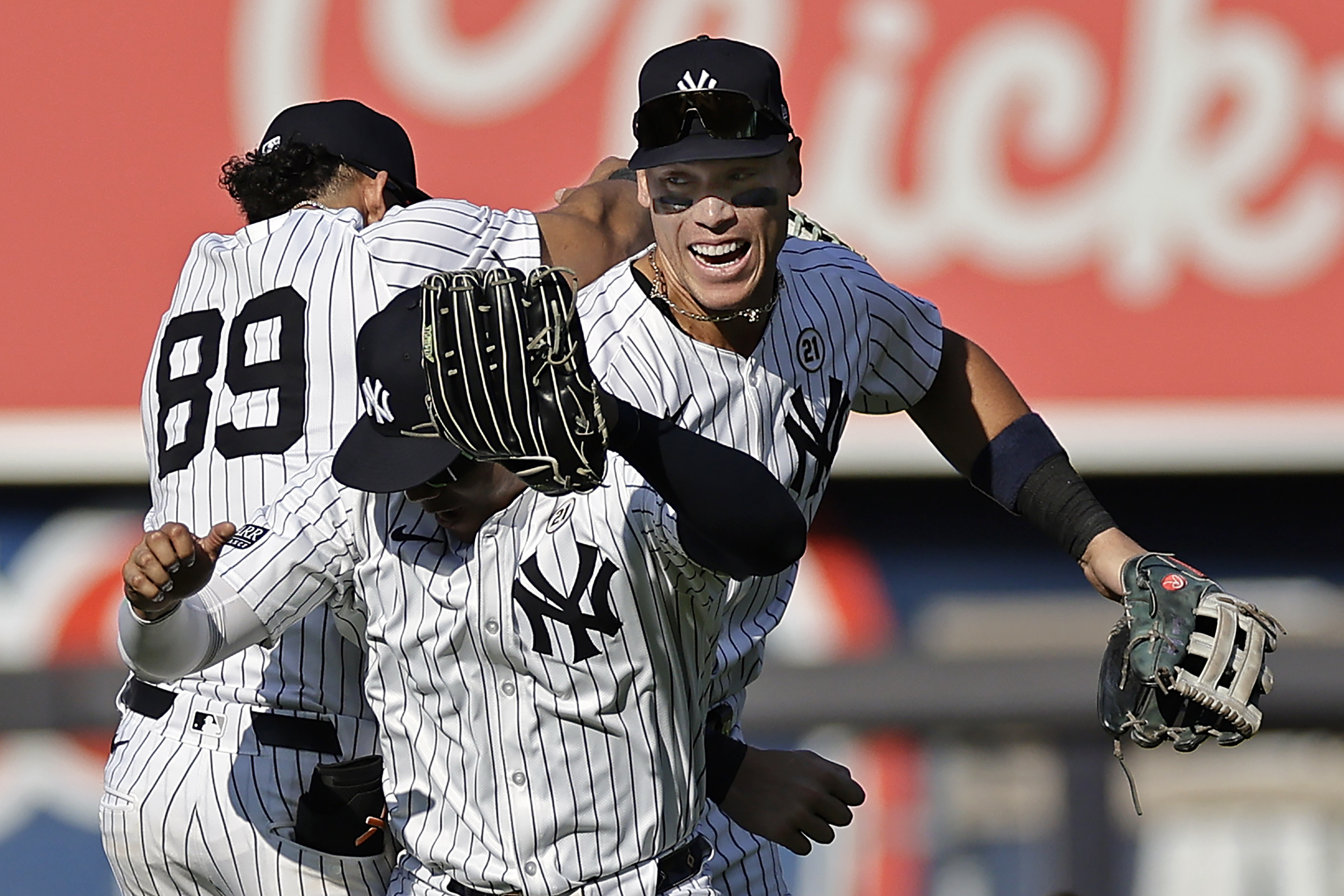 New York Yankees center fielder Aaron Judge, right, celebrates with Juan Soto, front, and Jasson Dominguez (89) after a baseball game against the Boston Red Sox, Sunday, Sept. 15, 2024, in New York. 