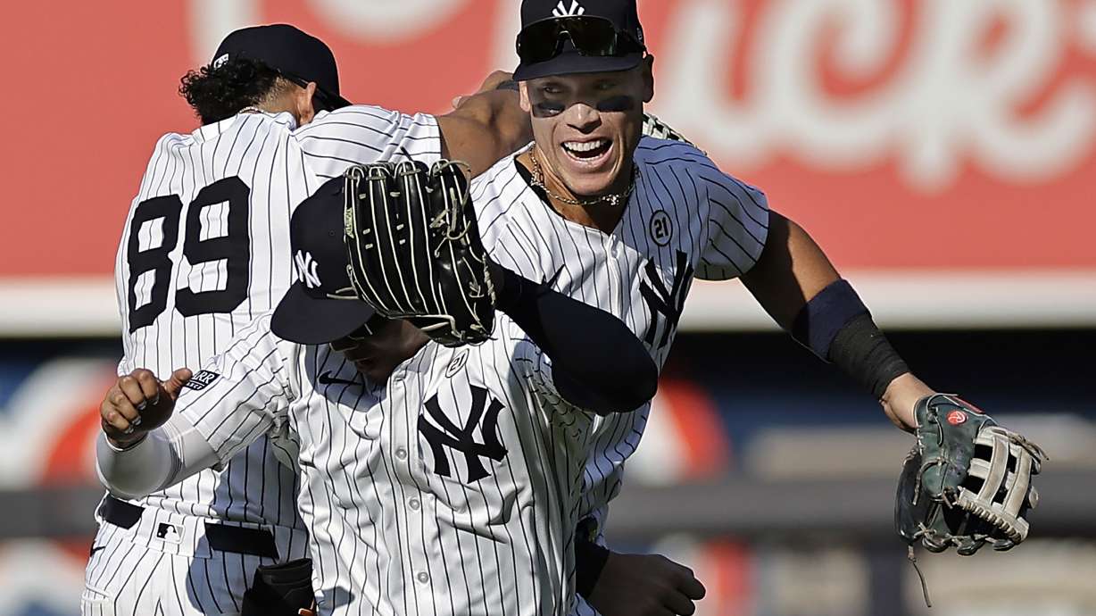 New York Yankees center fielder Aaron Judge, right, celebrates with Juan Soto, front, and Jasson Dominguez (89) after a baseball game against the Boston Red Sox, Sunday, Sept. 15, 2024, in New York.