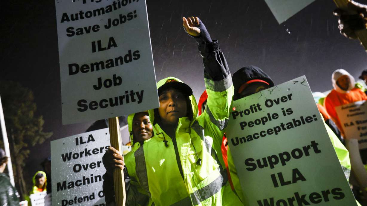 Dockworker Meikysha Wright and others strike outside the Virginia International Gateway in Portsmouth, Va., Tuesday.