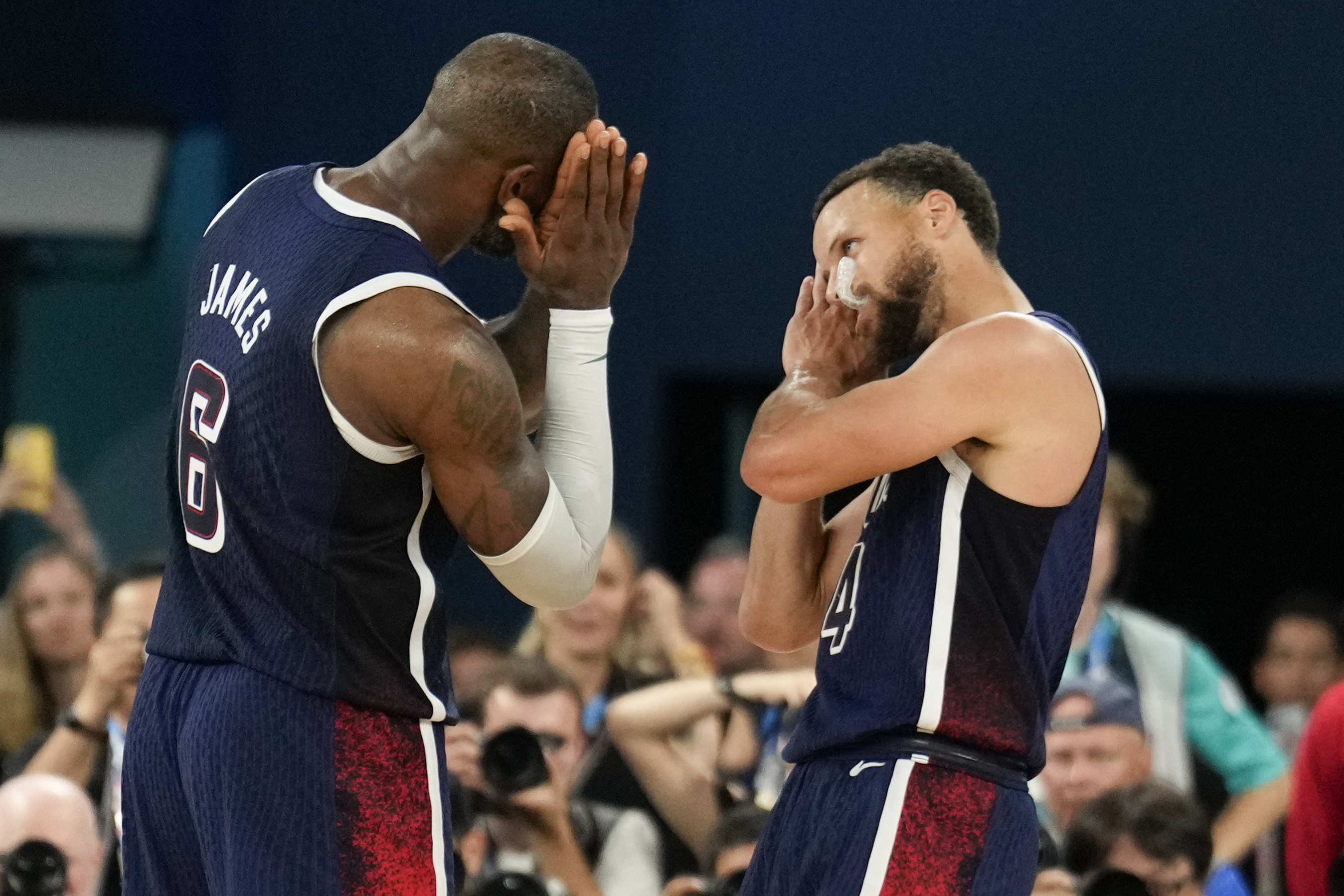 FILE - United States' Stephen Curry (4) and LeBron James (6) celebrate after beating France to win the gold medal during a men's gold medal basketball game at Bercy Arena at the 2024 Summer Olympics, Aug. 10, 2024, in Paris, France.