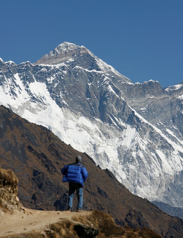 A tourist looks at a view of Mount Everest from the hills of Syangboche in Nepal Dec. 3, 2009.